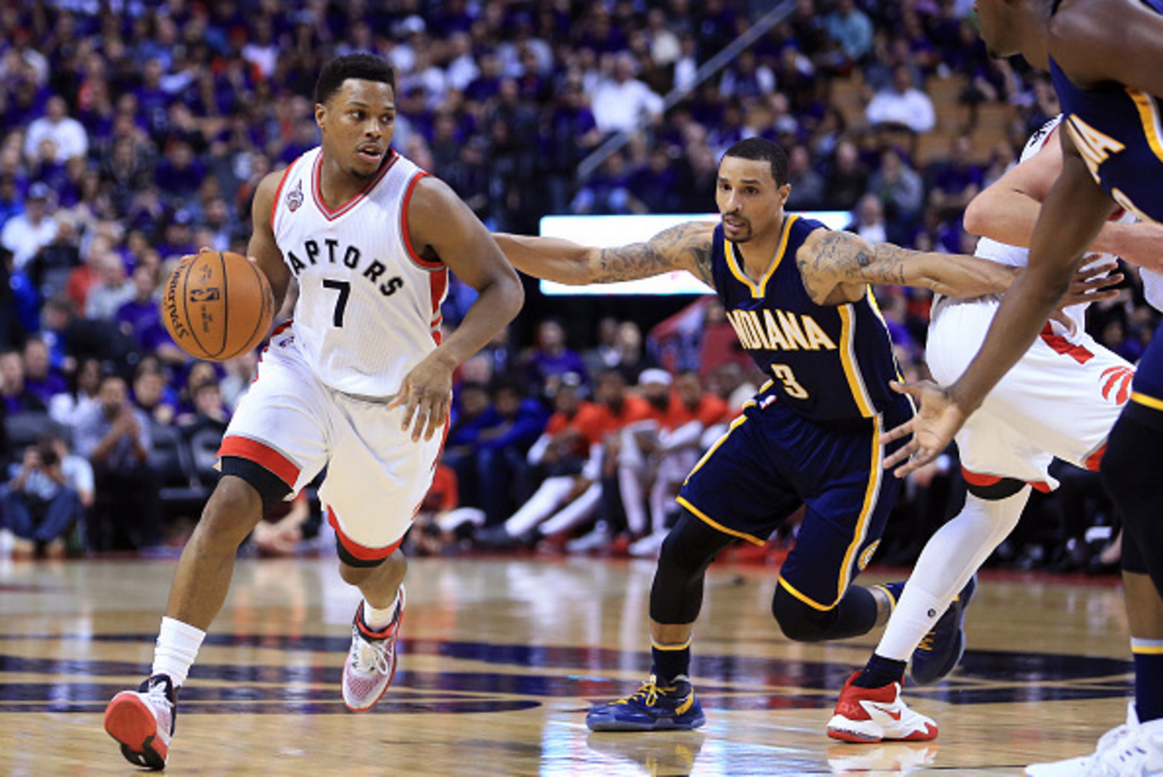 TORONTO, ON - APRIL 18:  Kyle Lowry #7 of the Toronto Raptors dribbles the ball past George Hill #3 of the Indiana Pacers in the second half of Game Two of the Eastern Conference Quarterfinals during the 2016 NBA Playoffs at the Air Canada Centre on April
