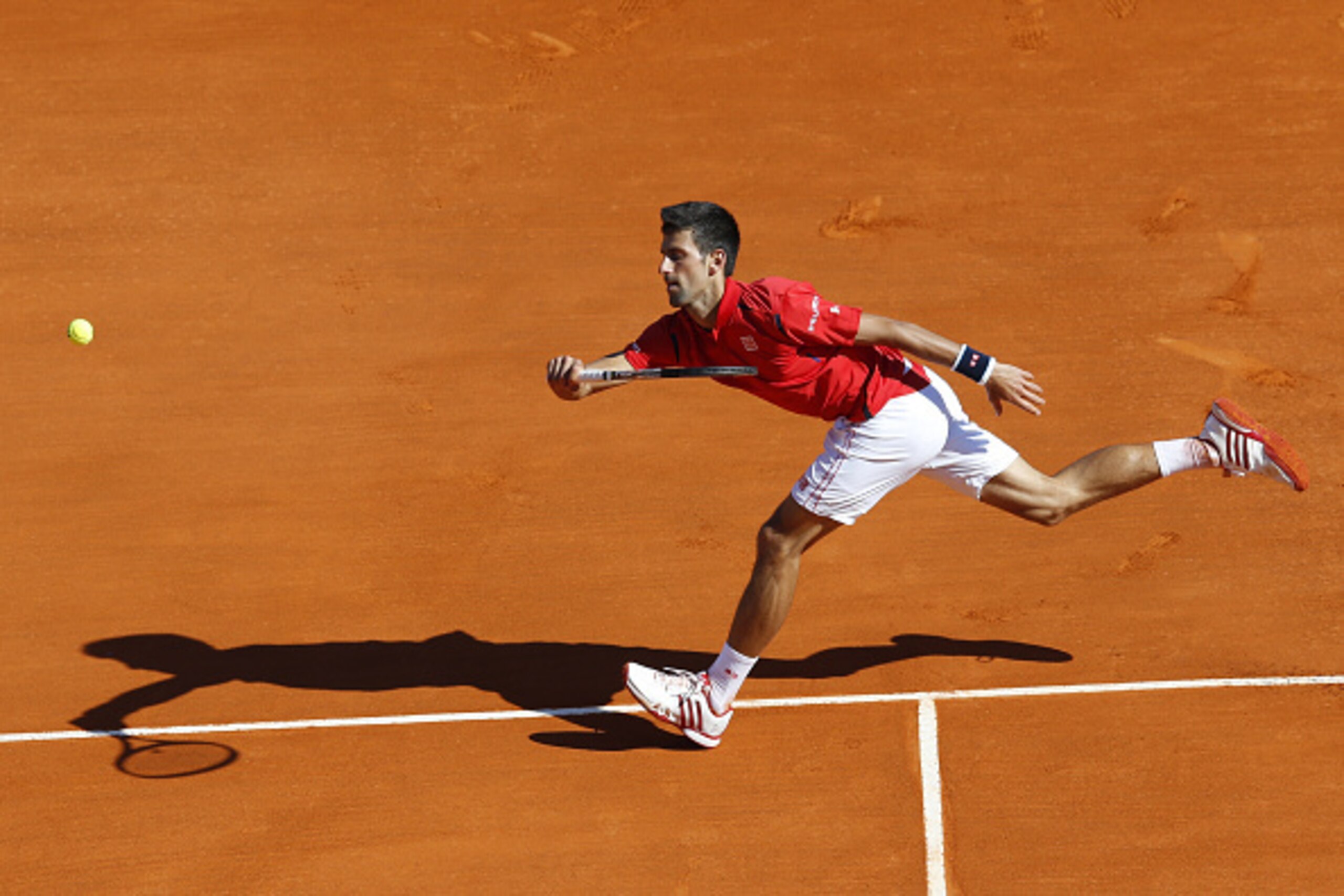 Serbia's Novak Djokovic returns a forehand to Czech Republic's Jiri Vesely during their tennis match at the Monte-Carlo ATP Masters Series tournament, on April 13, 2016 in Monaco.  AFP PHOTO / VALERY HACHE / AFP / VALERY HACHE        (Photo credit should 