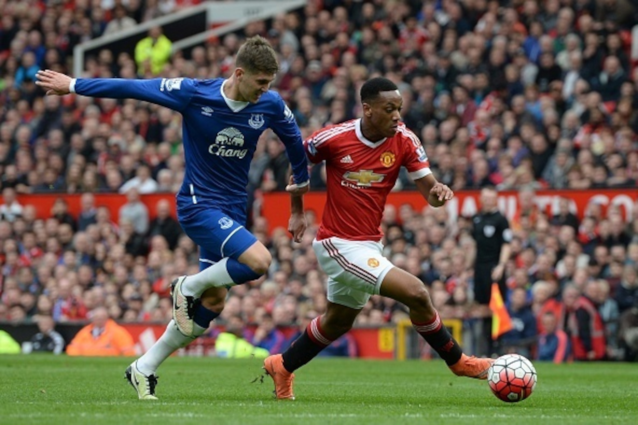 Manchester United's French striker Anthony Martial (R) takes on Everton's English defender John Stones (L) during the English Premier League football match between Manchester United and Everton at Old Trafford in Manchester, north west England, on April 3