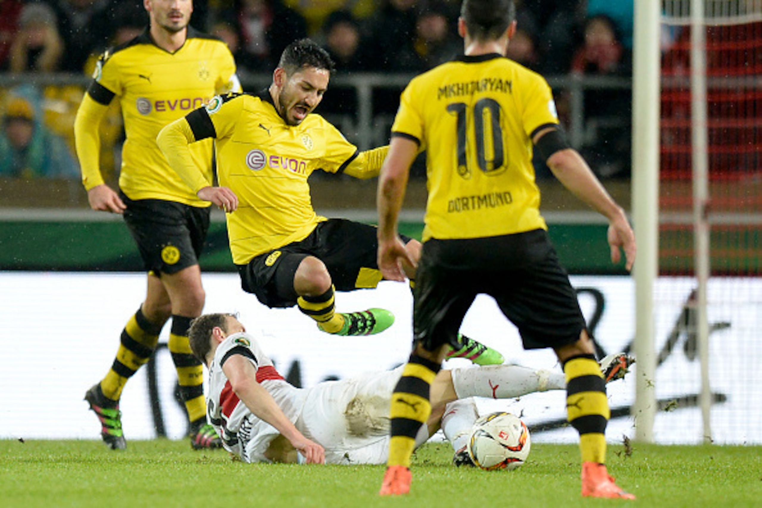 Stuttgart's defender Georg Niedermeier (on ground) and Dortmund's midfielder Ilkay Guendogan vie for the ball as defender Mats Hummels (L) and Armenian midfielder Henrikh Mkhitaryan (R) watch on during the German Cup ( Pokal ) quarter final football matc Stuttgart's defender Georg Niedermeier (on ground) and Dortmund's midfielder Ilkay Guendogan vie for the ball as defender Mats Hummels (L) and Armenian midfielder Henrikh Mkhitaryan (R) watch on during the German Cup ( Pokal ) quarter final football matc