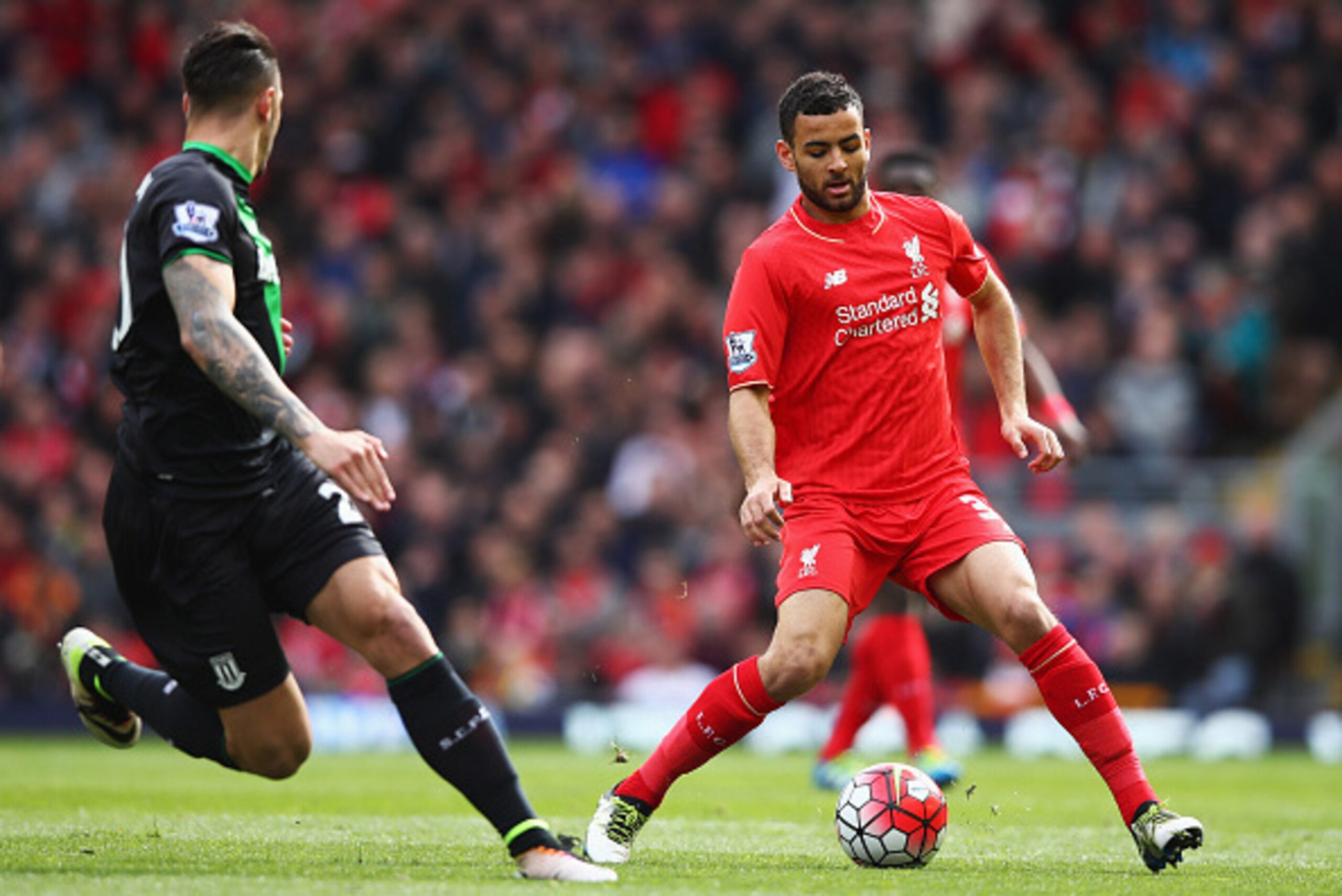 LIVERPOOL, UNITED KINGDOM - APRIL 10:  Kevin Stewart of Liverpool is watched by Geoff Cameron of Stoke City during the Barclays Premier League match between Liverpool and Stoke City at Anfield on April 10, 2016 in Liverpool, England.  (Photo by Clive Brun