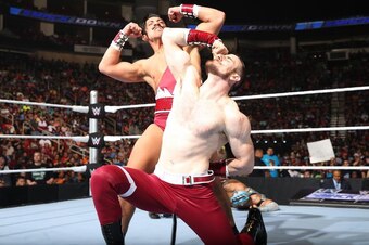 Simon Gotch and Aiden English pose after a win on SmackDown.