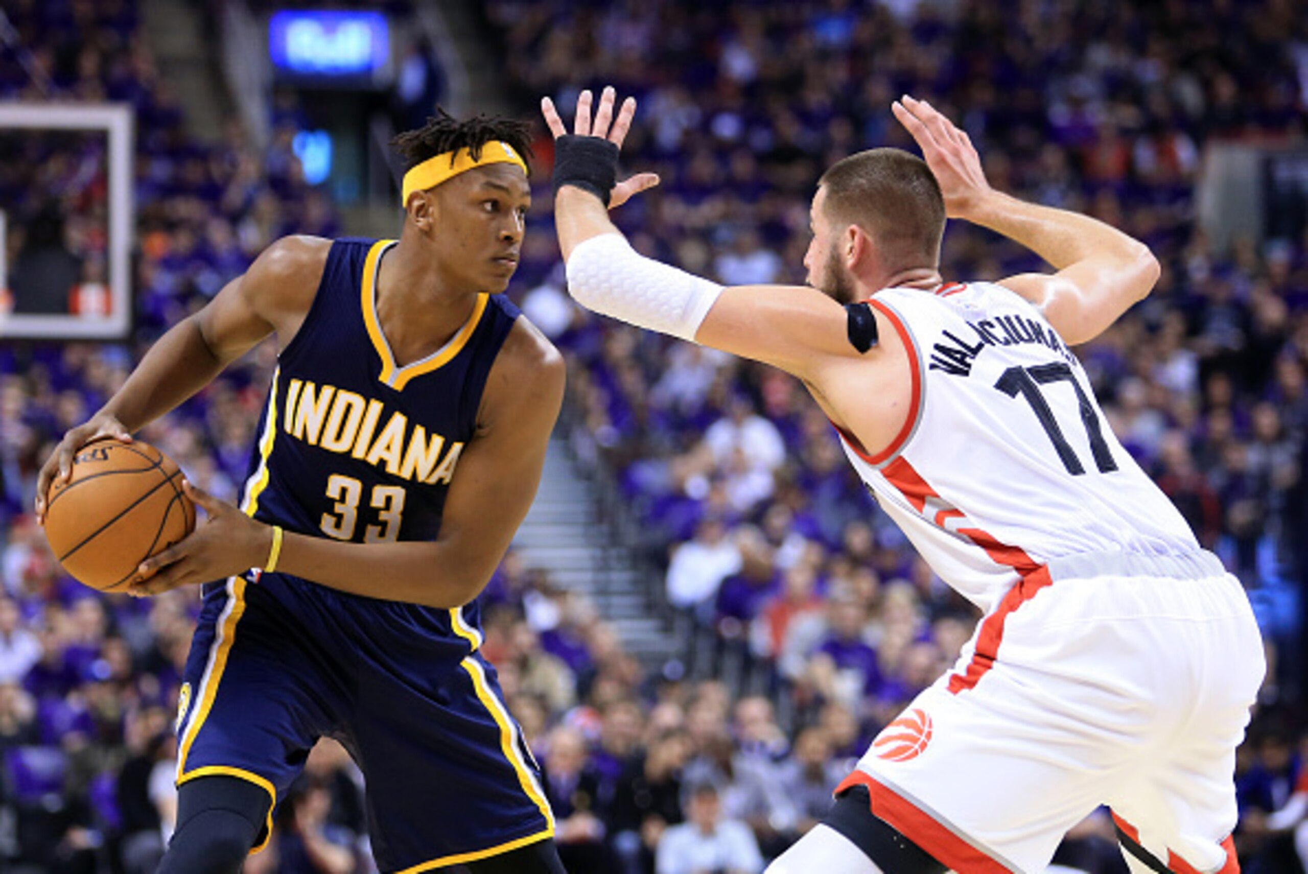 TORONTO, ON - APRIL 18:  Myles Turner #33 of the Indiana Pacers dribbles the ball as Jonas Valanciunas #17 of the Toronto Raptors defends in the first half of Game Two of the Eastern Conference Quarterfinals during the 2016 NBA Playoffs at the Air Canada 