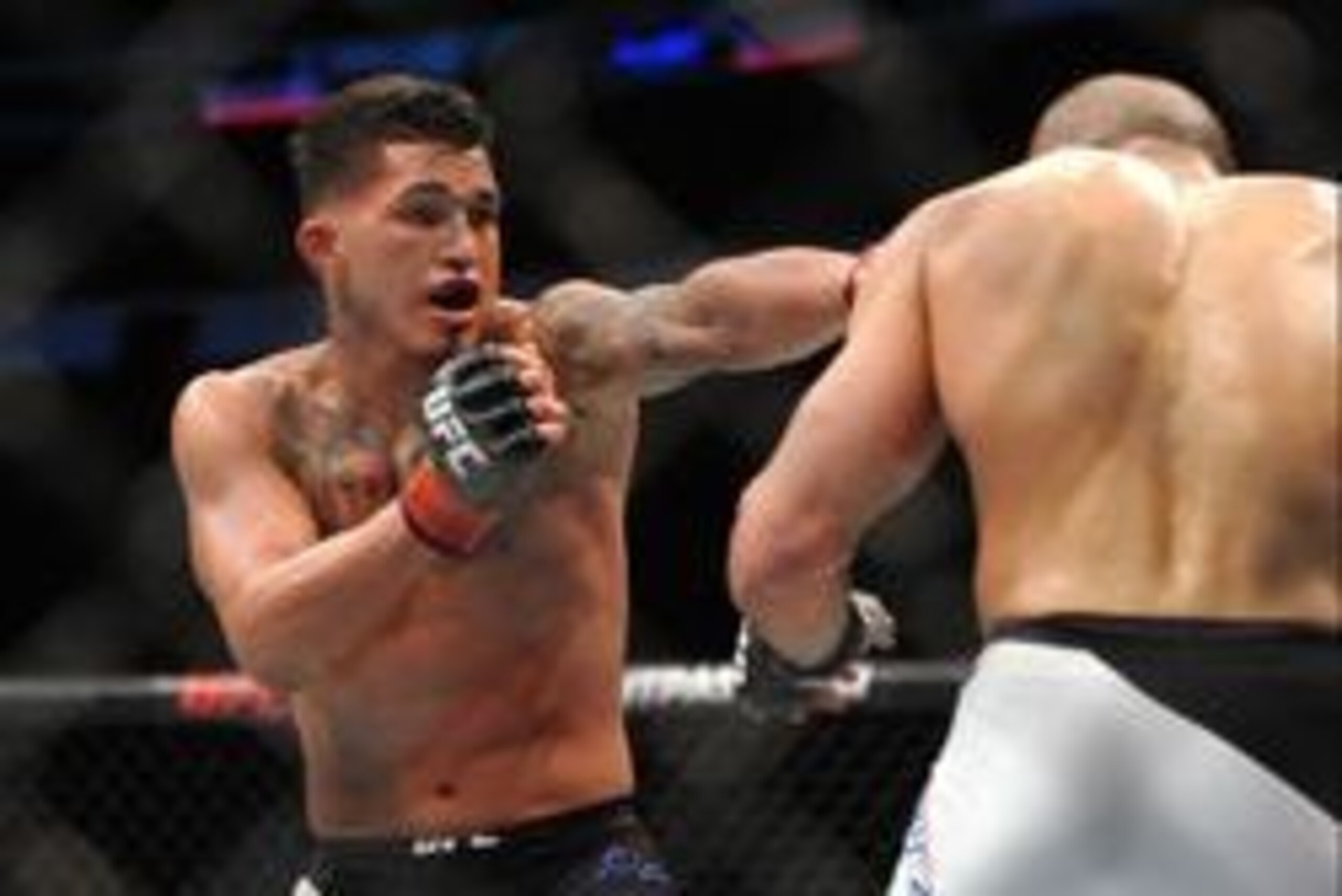 Jan 17, 2016; Boston, MA, USA; Anthony Pettis (red) punches Eddie Alvarez (blue) during a lightweight bout at UFC Fight Night at the TD Garden. Alvarez won after three rounds by split decision.   Mandatory Credit: Bob DeChiara-USA TODAY Sports