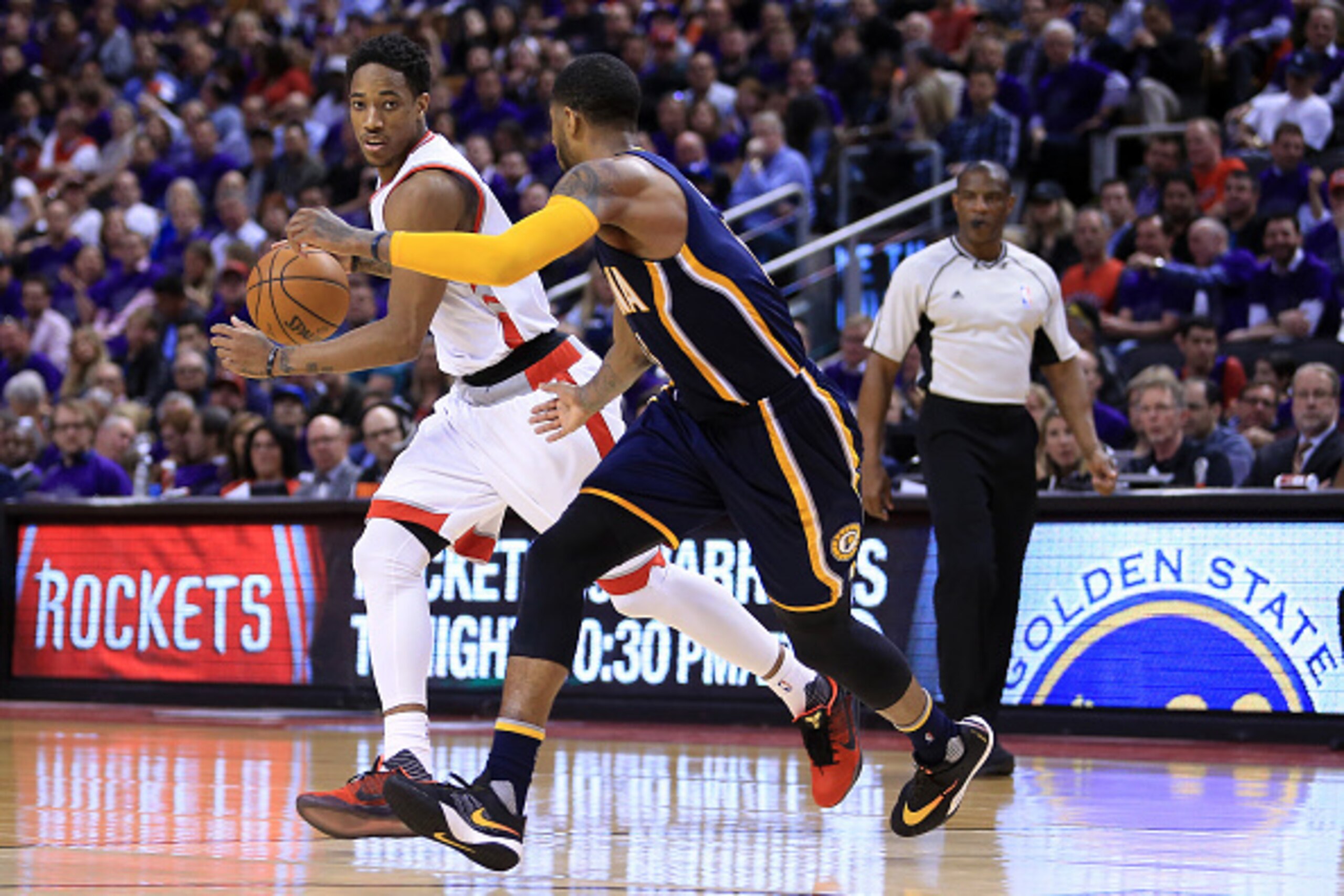 TORONTO, ON - APRIL 18:  DeMar DeRozan #10 of the Toronto Raptors dribbles the ball past Paul George #13 of the Indiana Pacers in the second half of Game Two of the Eastern Conference Quarterfinals during the 2016 NBA Playoffs at the Air Canada Centre on 