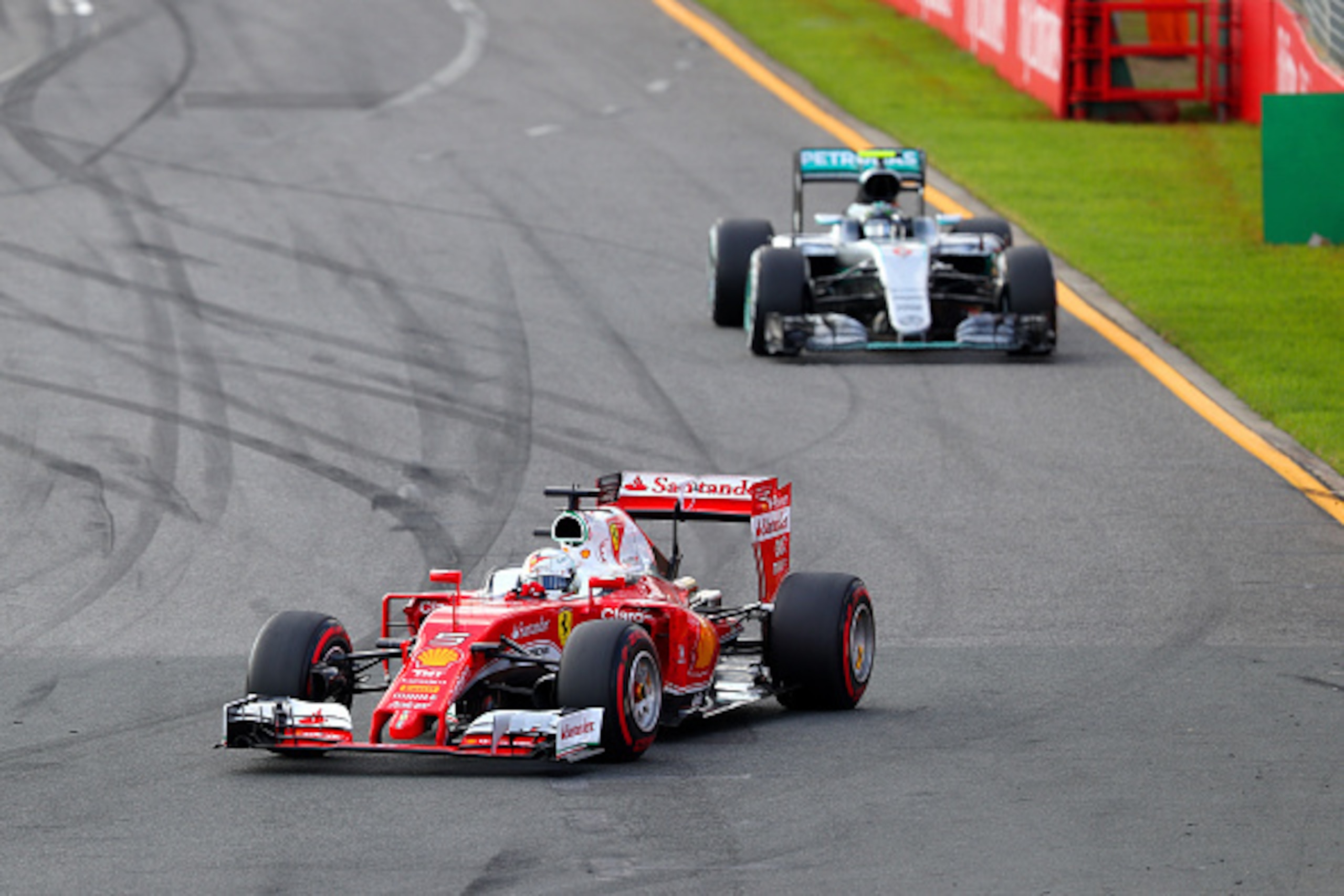 MELBOURNE, AUSTRALIA - MARCH 20: Sebastian Vettel of Germany and Ferrari drives ahead of Nico Rosberg of Germany and Mercedes GP during the Australian Formula One Grand Prix at Albert Park on March 20, 2016 in Melbourne, Australia. (Photo by Clive Mason MELBOURNE, AUSTRALIA - MARCH 20: Sebastian Vettel of Germany and Ferrari drives ahead of Nico Rosberg of Germany and Mercedes GP during the Australian Formula One Grand Prix at Albert Park on March 20, 2016 in Melbourne, Australia. (Photo by Clive Mason