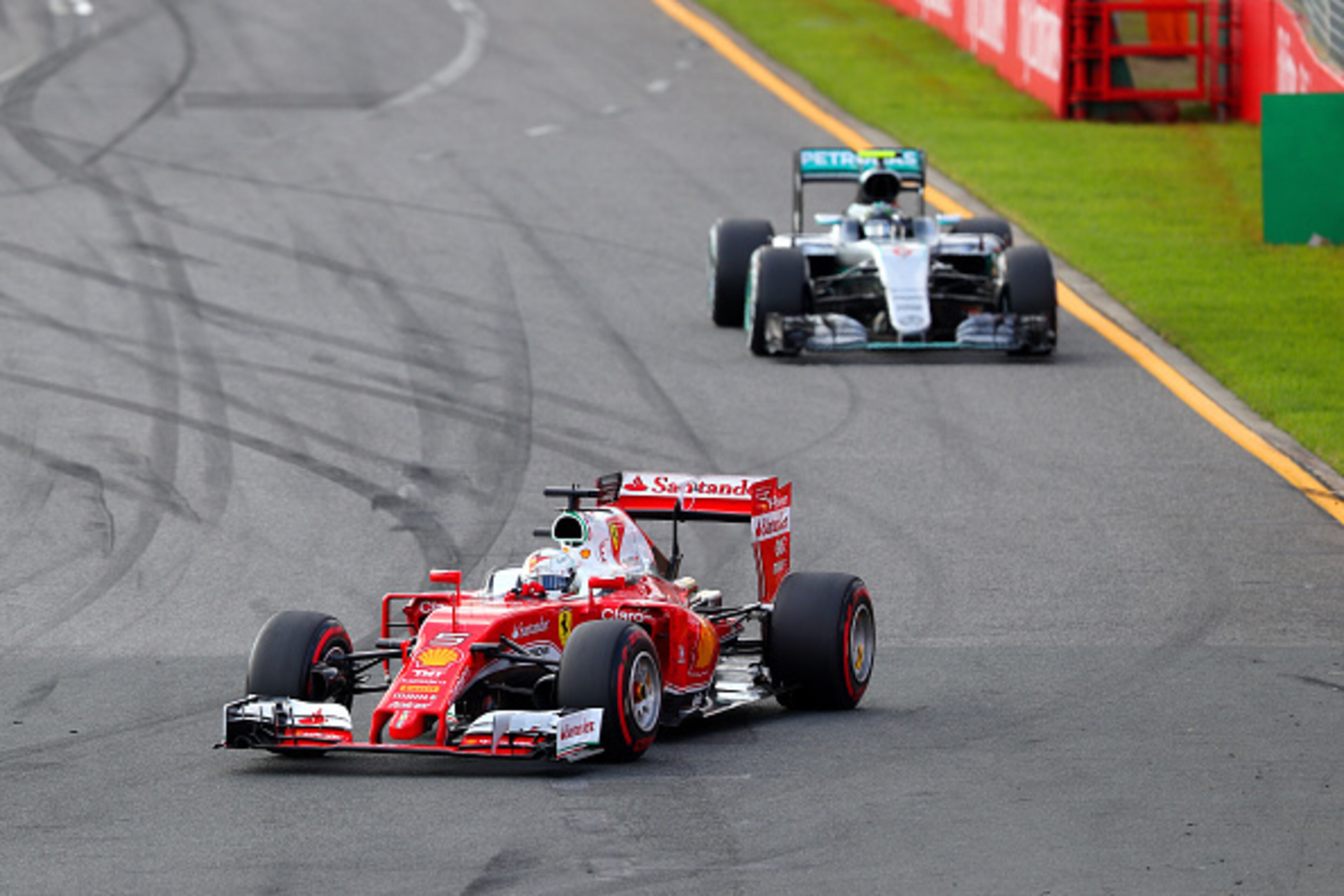 MELBOURNE, AUSTRALIA - MARCH 20:  Sebastian Vettel of Germany and Ferrari drives ahead of Nico Rosberg of Germany and Mercedes GP during the Australian Formula One Grand Prix at Albert Park on March 20, 2016 in Melbourne, Australia.  (Photo by Clive Mason