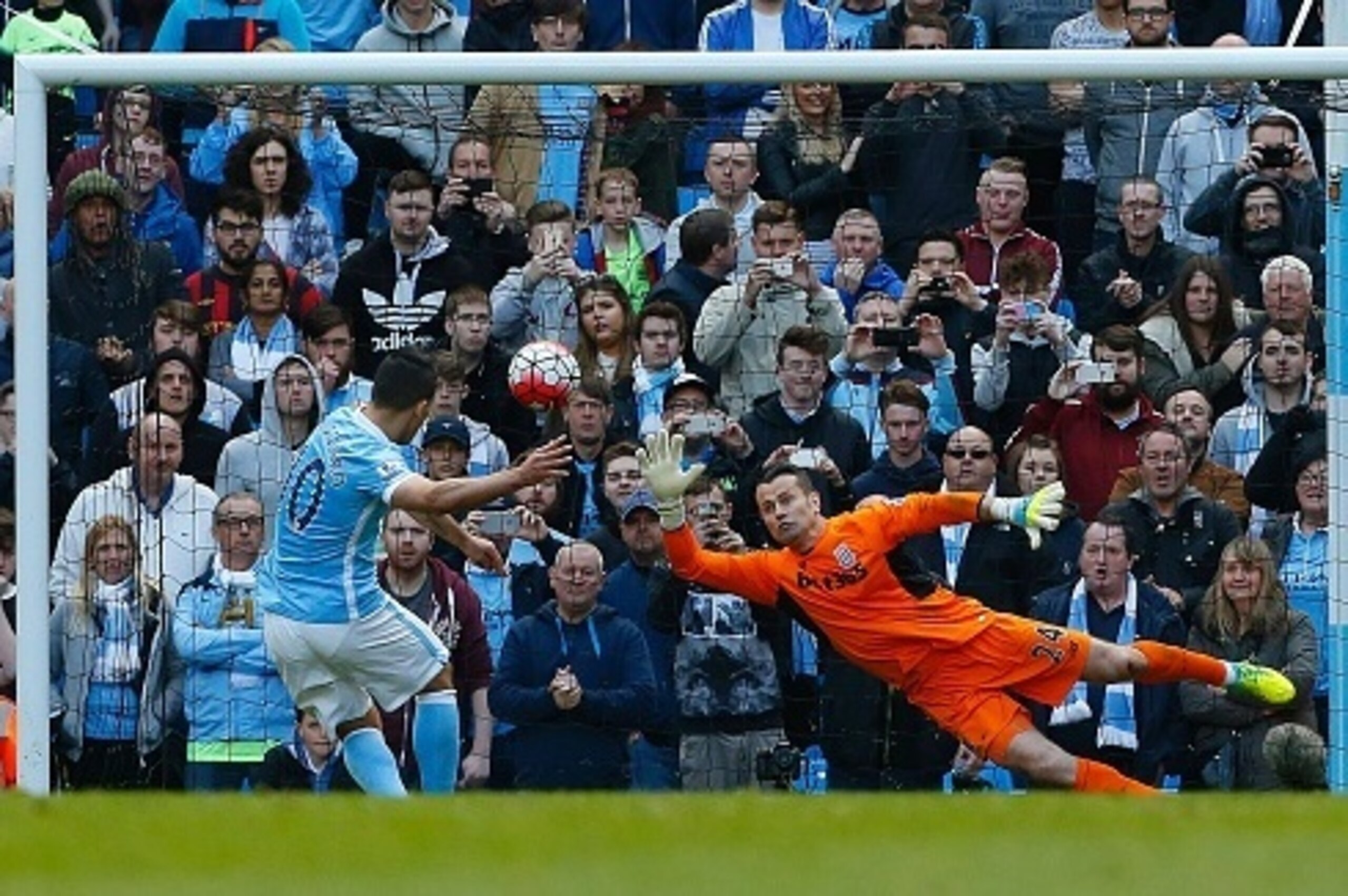 Manchester City's Argentinian striker Sergio Aguero scores their second goal past Stoke City's Irish goalkeeper Shay Given (R) from the penalty spot during the English Premier League football match between Manchester City and Stoke City at the Etihad Stad Manchester City's Argentinian striker Sergio Aguero scores their second goal past Stoke City's Irish goalkeeper Shay Given (R) from the penalty spot during the English Premier League football match between Manchester City and Stoke City at the Etihad Stad