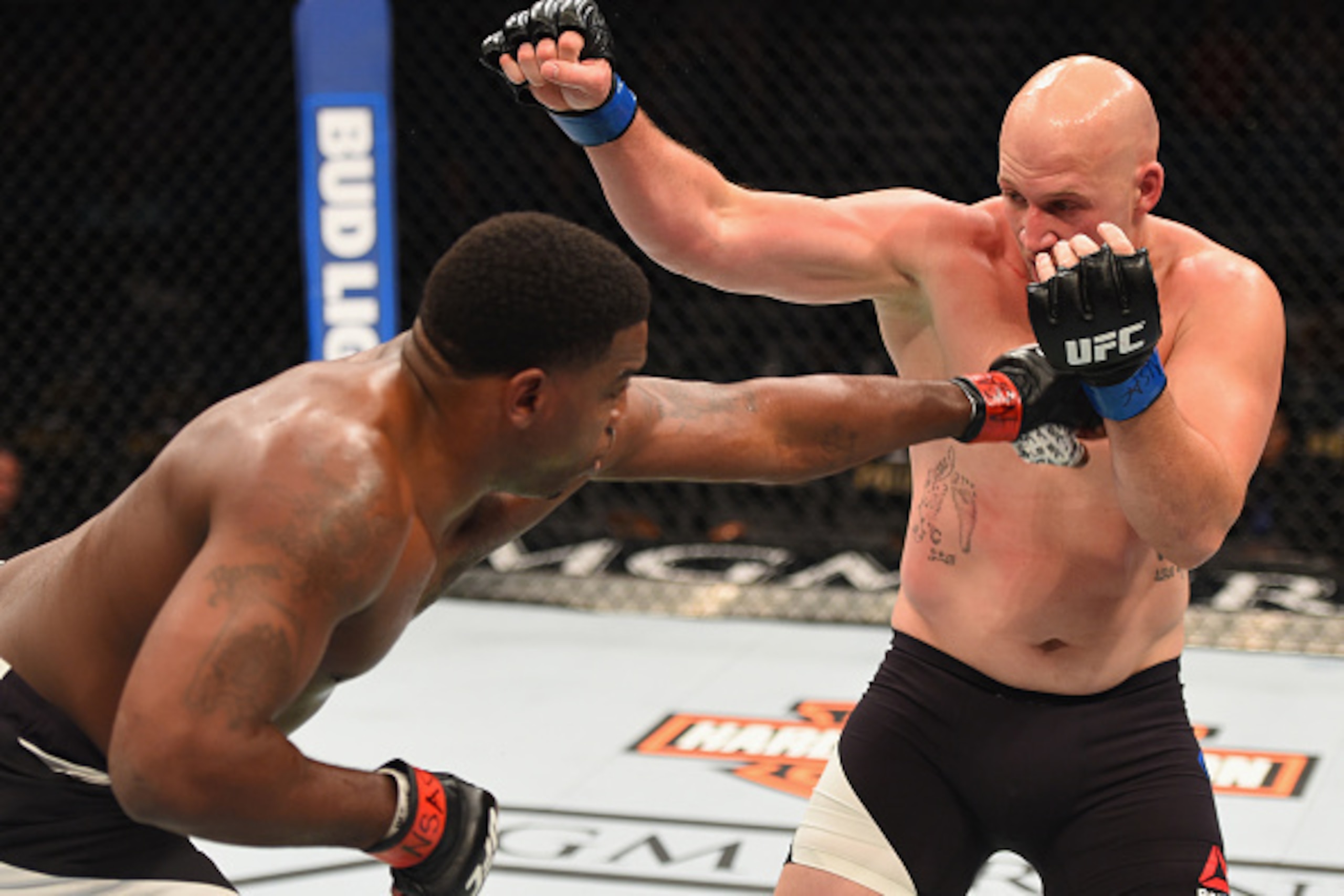 LAS VEGAS, NV - APRIL 23:  (L-R) Walt Harris punches Cody East in their heavyweight bout during the UFC 197 event inside MGM Grand Garden Arena on April 23, 2016 in Las Vegas, Nevada.  (Photo by Josh Hedges/Zuffa LLC/Zuffa LLC via Getty Images)