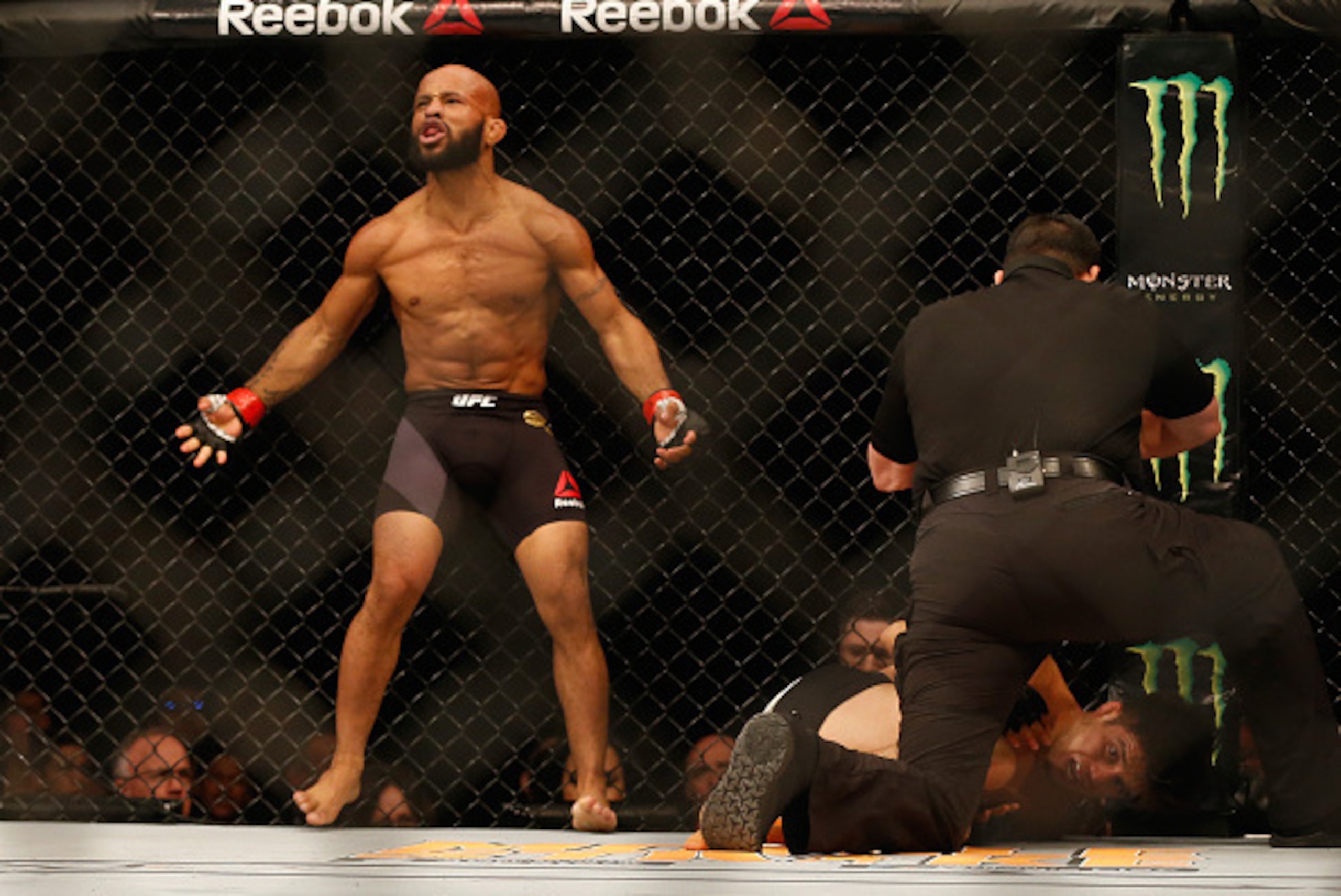 LAS VEGAS, NV - APRIL 23:  Demetrious Johnson celebrates his TKO victory over Henry Cejudo in their flyweight championship bout during the UFC 197 event inside MGM Grand Garden Arena on April 23, 2016 in Las Vegas, Nevada.  (Photo by Christian Petersen/Zu