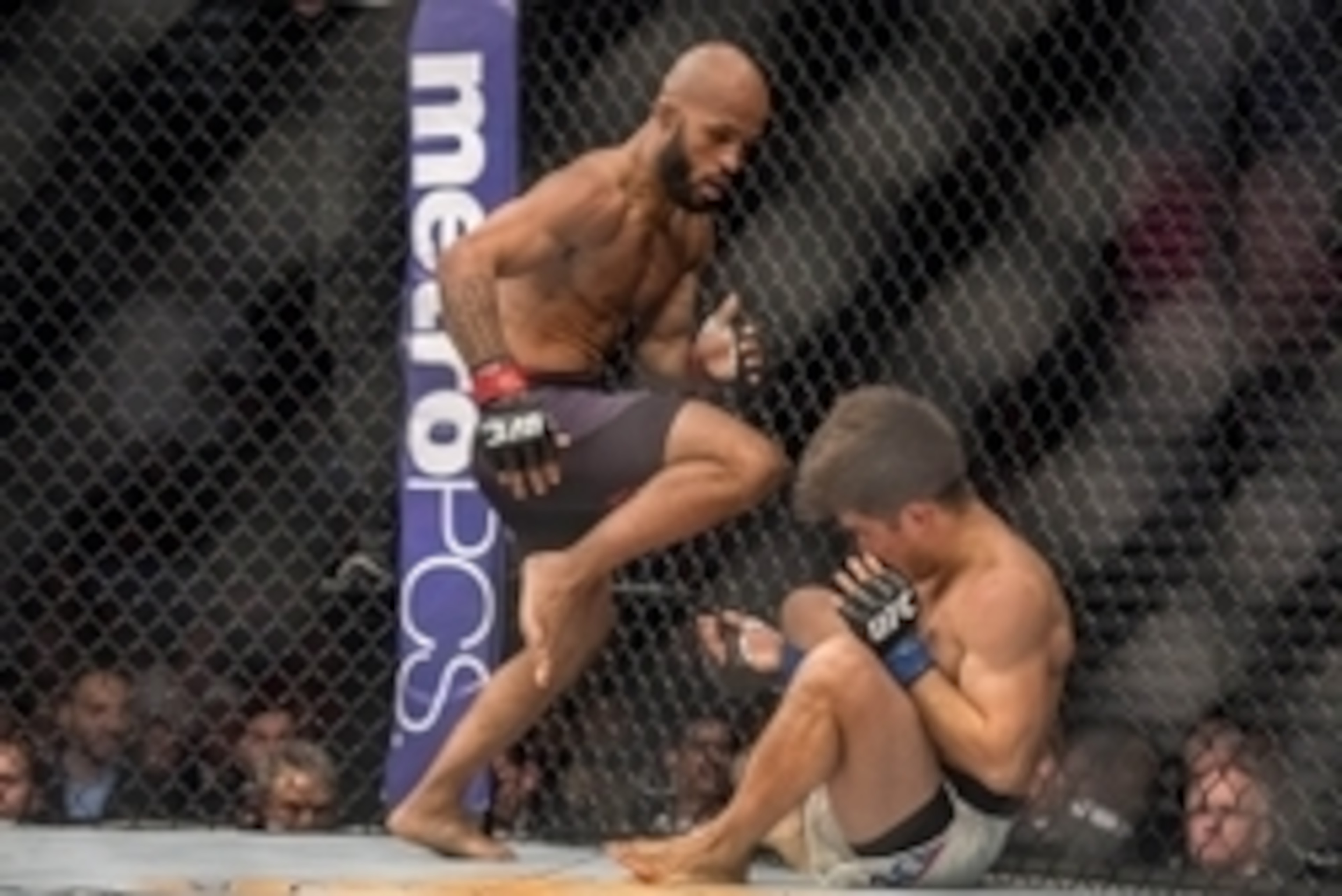 Apr 23, 2016; Las Vegas, NV, USA; Demetrious Johnson (red gloves) knocks down Henry Cejudo (blue gloves) during UFC 197 at MGM Grand Garden Arena. Mandatory Credit: Joshua Dahl-USA TODAY Sports