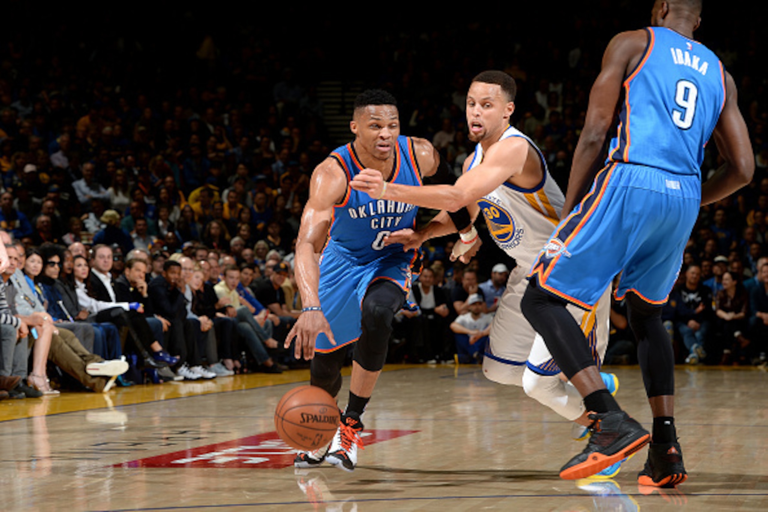 OAKLAND, CA - MARCH 3: Russell Westbrook #0 of the Oklahoma City Thunder handles the ball during the game against Stephen Curry #30 of the Golden State Warriors on March 3, 2016 at ORACLE Arena in Oakland, California. NOTE TO USER: User expressly acknowle