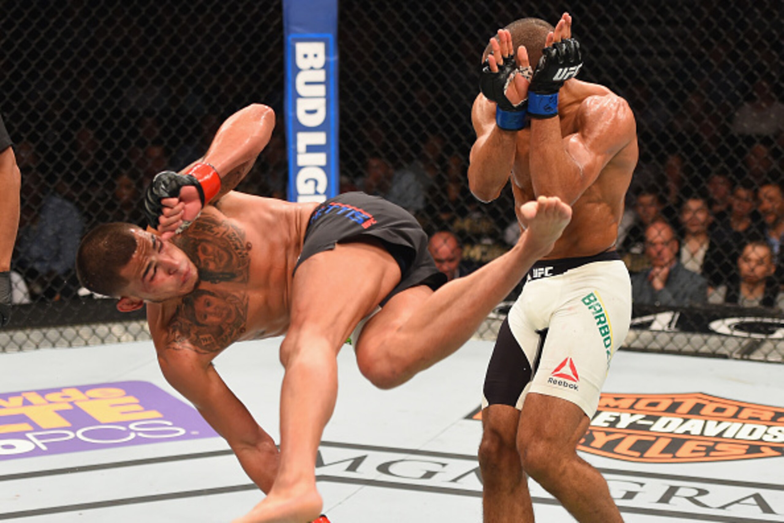 LAS VEGAS, NV - APRIL 23:  (L-R) Anthony Pettis kicks Edson Barboza in their lightweight bout during the UFC 197 event inside MGM Grand Garden Arena on April 23, 2016 in Las Vegas, Nevada.  (Photo by Josh Hedges/Zuffa LLC/Zuffa LLC via Getty Images)