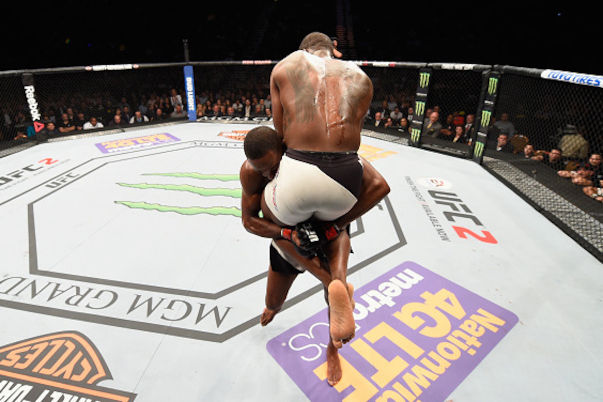 LAS VEGAS, NV - APRIL 23:  (L-R) Jon Jones picks up Ovince Saint Preux in their interim UFC light heavyweight championship bout during the UFC 197 event inside MGM Grand Garden Arena on April 23, 2016 in Las Vegas, Nevada.  (Photo by Josh Hedges/Zuffa LLC