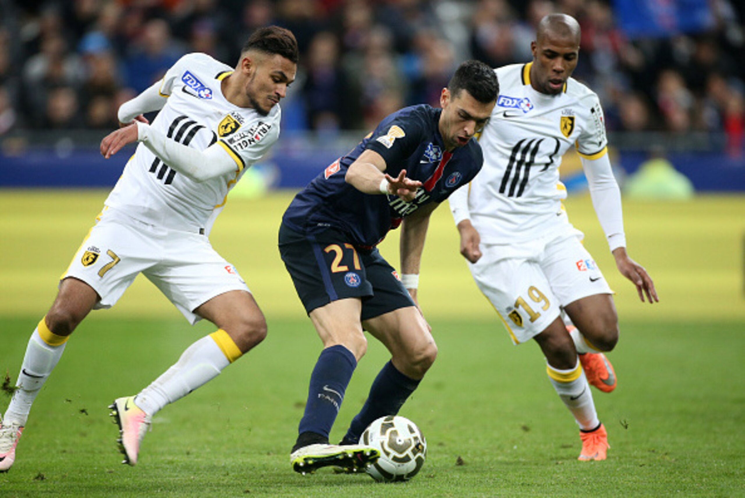 PARIS, FRANCE - APRIL 23: Javier Pastore of PSG in action between Sofiane Boufal and Djibril Sidibe of Lille during the French League Cup final (finale de la Coupe de la Ligue) between Paris Saint-Germain (PSG) and Lille OSC (LOSC) at Stade de France on A PARIS, FRANCE - APRIL 23: Javier Pastore of PSG in action between Sofiane Boufal and Djibril Sidibe of Lille during the French League Cup final (finale de la Coupe de la Ligue) between Paris Saint-Germain (PSG) and Lille OSC (LOSC) at Stade de France on A