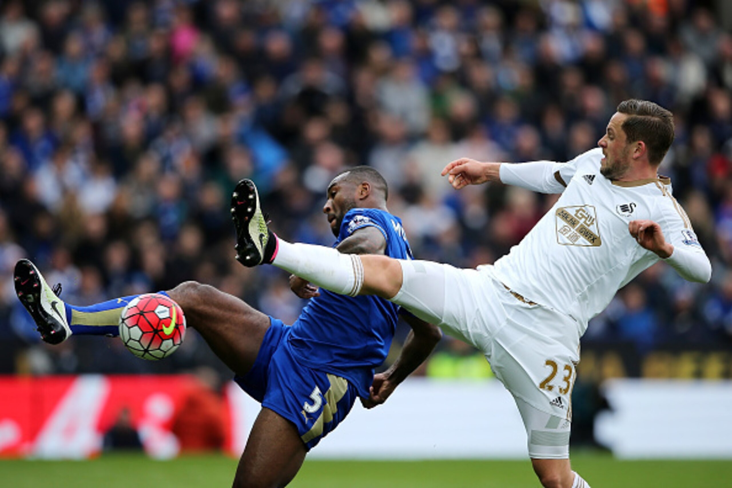 LEICESTER, ENGLAND - APRIL 24:  Gylfi Sigurdsson of Swansea City challenges Wes Morgan of Leicester City during the Barclays Premier League match between Leicester City and Swansea City at The King Power Stadium on April 24, 2016 in Leicester, United King