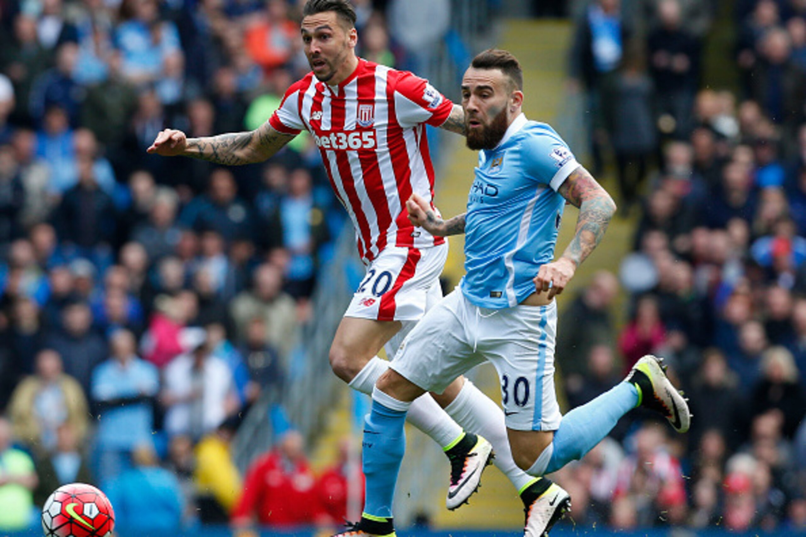 Stoke City's US defender Geoff Cameron (L) vies with Manchester City's Argentinian defender Nicolas Otamendi during the English Premier League football match between Manchester City and Stoke City at the Etihad Stadium in Manchester, north west England, o