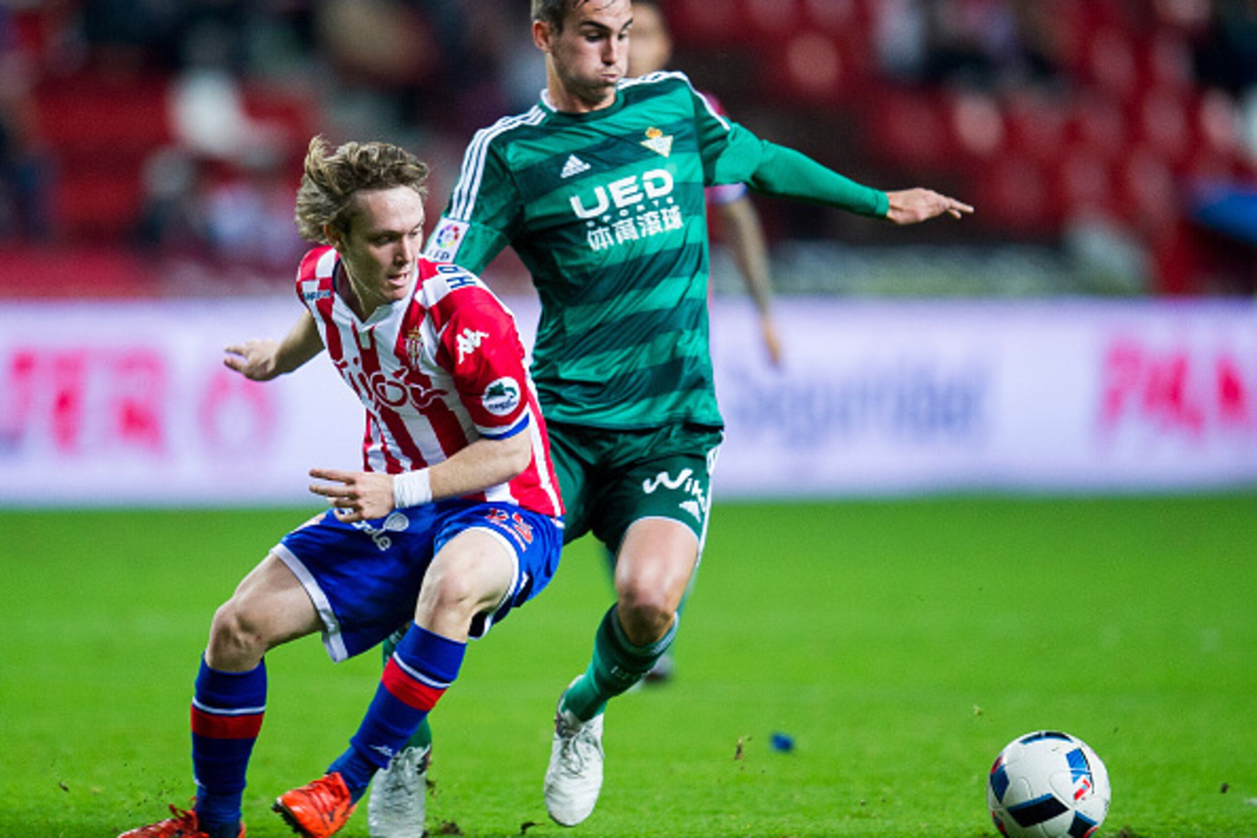 GIJON, SPAIN - DECEMBER 15: Fabian Ruiz Pena of Real Betis Balompie duels for the ball with Halilovic of Real Sporting de Gijon during the Copa del Rey Round of 32 match between Real Sporting de Gijon and Real Betis Balompie at Estadio El Molinon on Dece GIJON, SPAIN - DECEMBER 15: Fabian Ruiz Pena of Real Betis Balompie duels for the ball with Halilovic of Real Sporting de Gijon during the Copa del Rey Round of 32 match between Real Sporting de Gijon and Real Betis Balompie at Estadio El Molinon on Dece