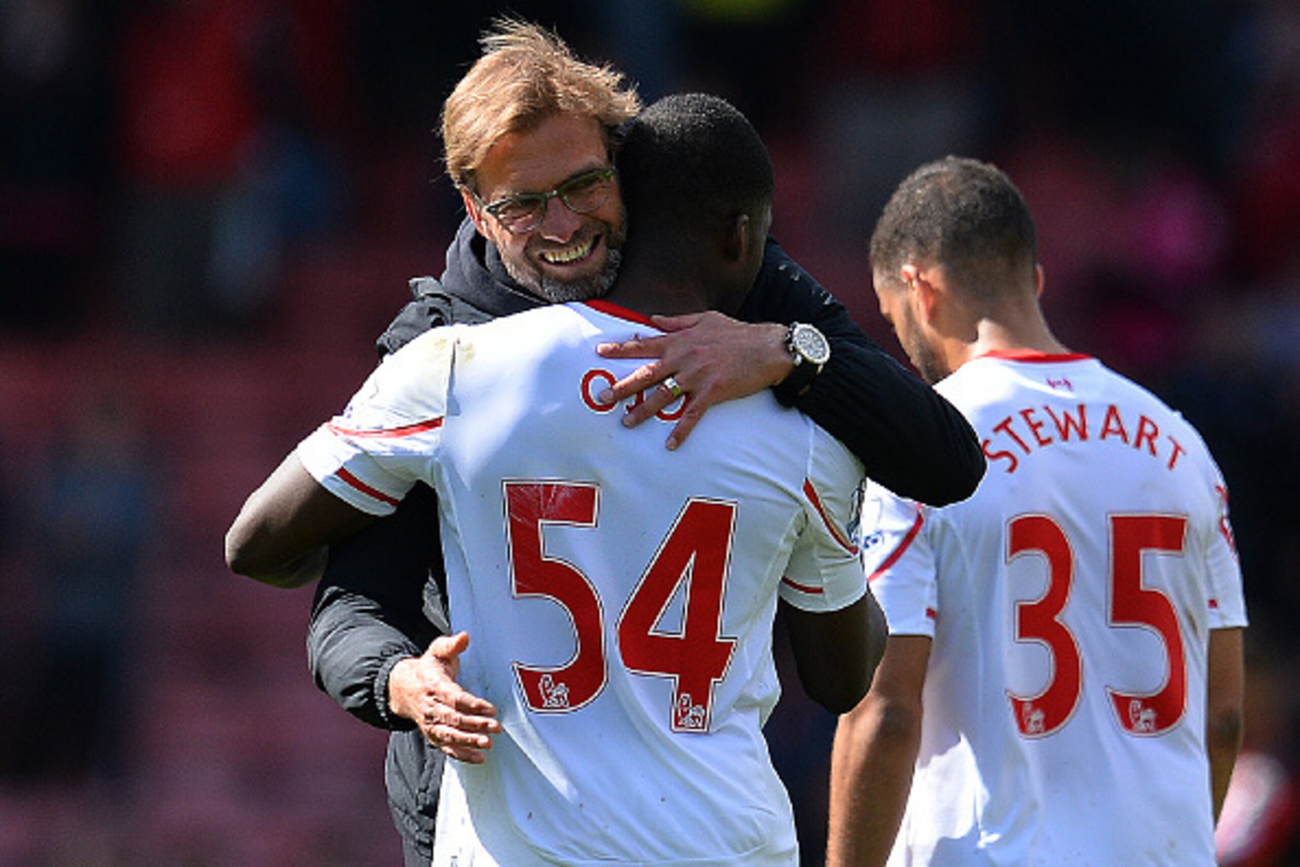 Liverpool's German manager Jurgen Klopp (L) hugs Liverpool's English midfielder Oluwaseyi Ojo following the English Premier League football match between Bournemouth and Liverpool at the Vitality Stadium in Bournemouth, southern England on April 17, 2016.