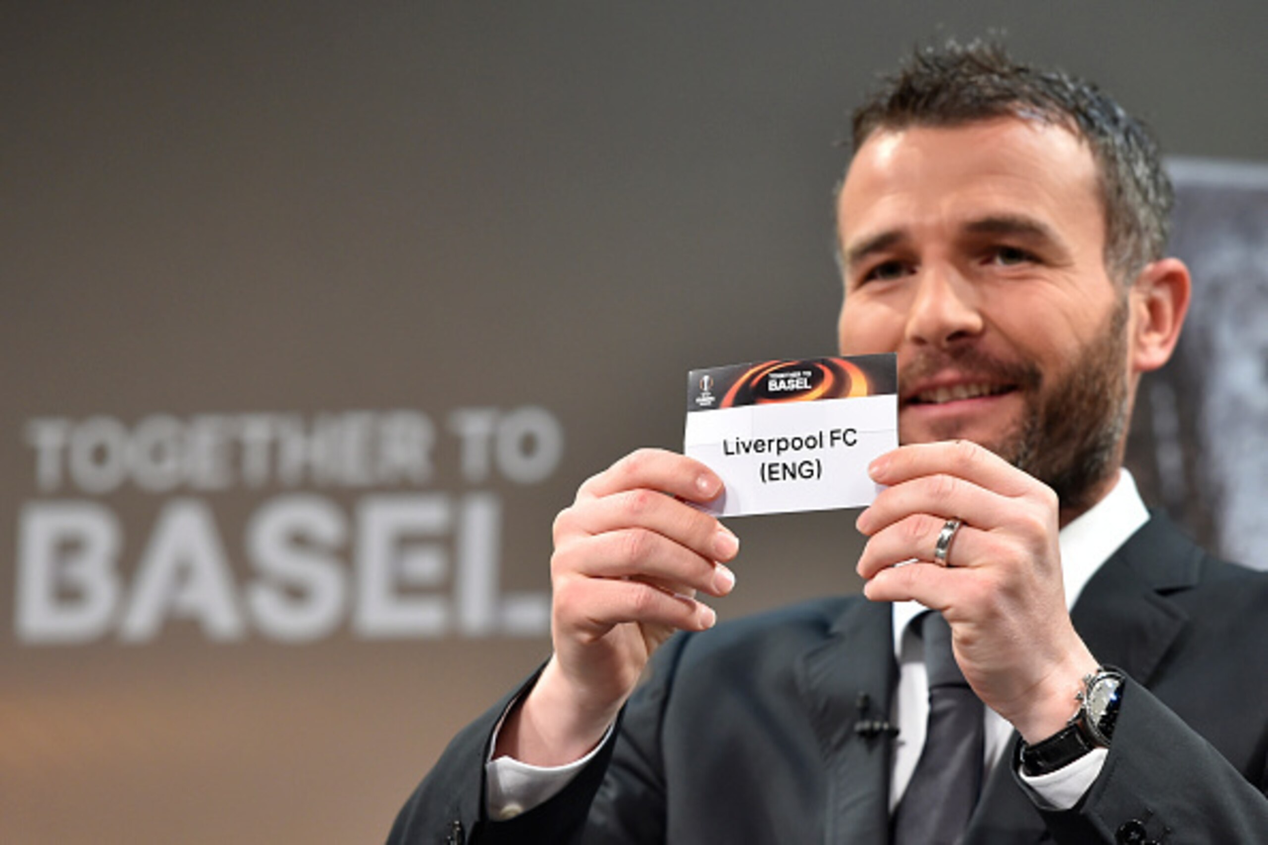 Former Swiss striker and 2016 UEFA Europa League final ambassador Alexander Frei shows the name of Liverpool during the semi-final draw for the UEFA Europa League at the UEFA headquarters in Nyon on April 15, 2016.   AFP PHOTO / FABRICE COFFRINI / AFP / F