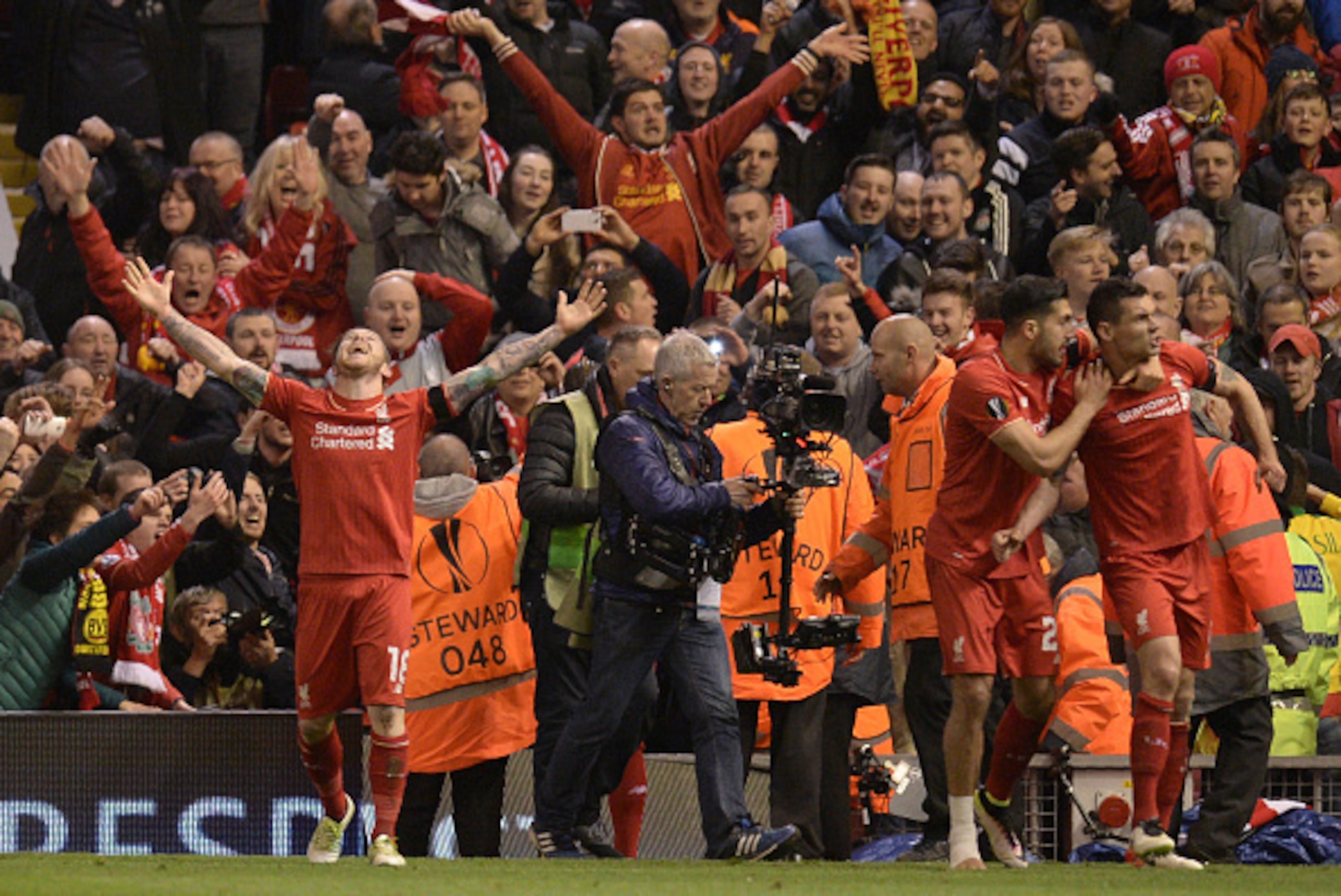 Liverpool's Croatian defender Dejan Lovren (R) celebrates after scoring the winning goal during the UEFA Europa league quarter-final second leg football match between Liverpool  and Borussia Dortmund at Anfield stadium in Liverpool on April 14, 2016. / AF