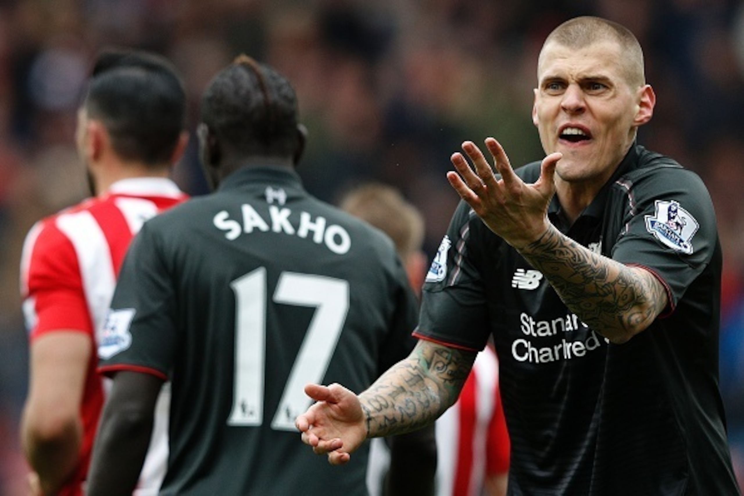 Liverpool's Slovakian defender Martin Skrtel (R) reacts after Referee Roger East (not pictured) showed him a yellow card following his challenge on Southampton's Italian striker Graziano Pelle (not pictured), and awarding Southampton a penalty during the 