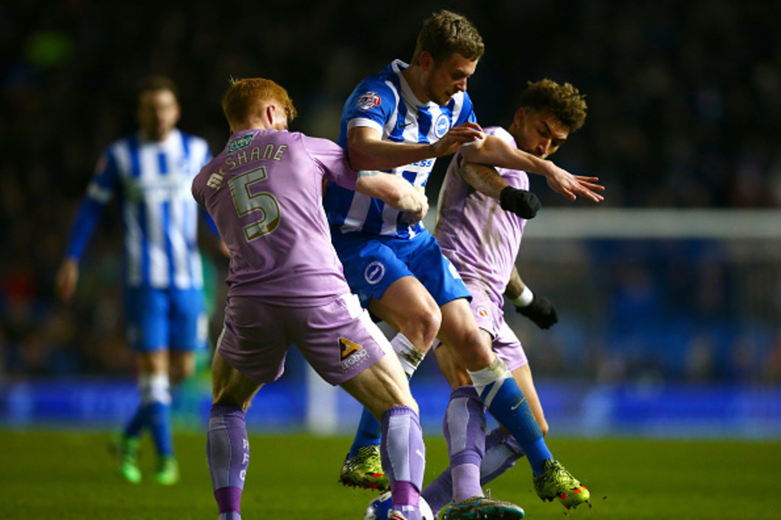 BRIGHTON, ENGLAND - MARCH 15:  James Wilson of Brighton & Hove Albion battles for the ball with Paul McShane and Daniel Williams of Reading during the Sky Bet Championship match between Brighton and Hove Albion and Reading at Amex Stadium on March 15, 201