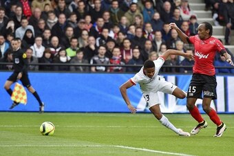 Guingamp's French defender Jeremy Sorbon (R) fools Paris Saint-Germain's midfielder Christopher Alan Nkunku and gives Paris a penalty kick during the French L1 football match Guingamp vs Paris SG at the Roudourou stadium in Guingamp, western France, on Ap