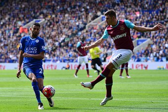 LEICESTER, ENGLAND - APRIL 17:  Riyad Mahrez of Leicester City blocks the clearance of Aaron Cresswell of West Ham United during the Barclays Premier League match between Leicester City and West Ham United at The King Power Stadium on April 17, 2016 in Le