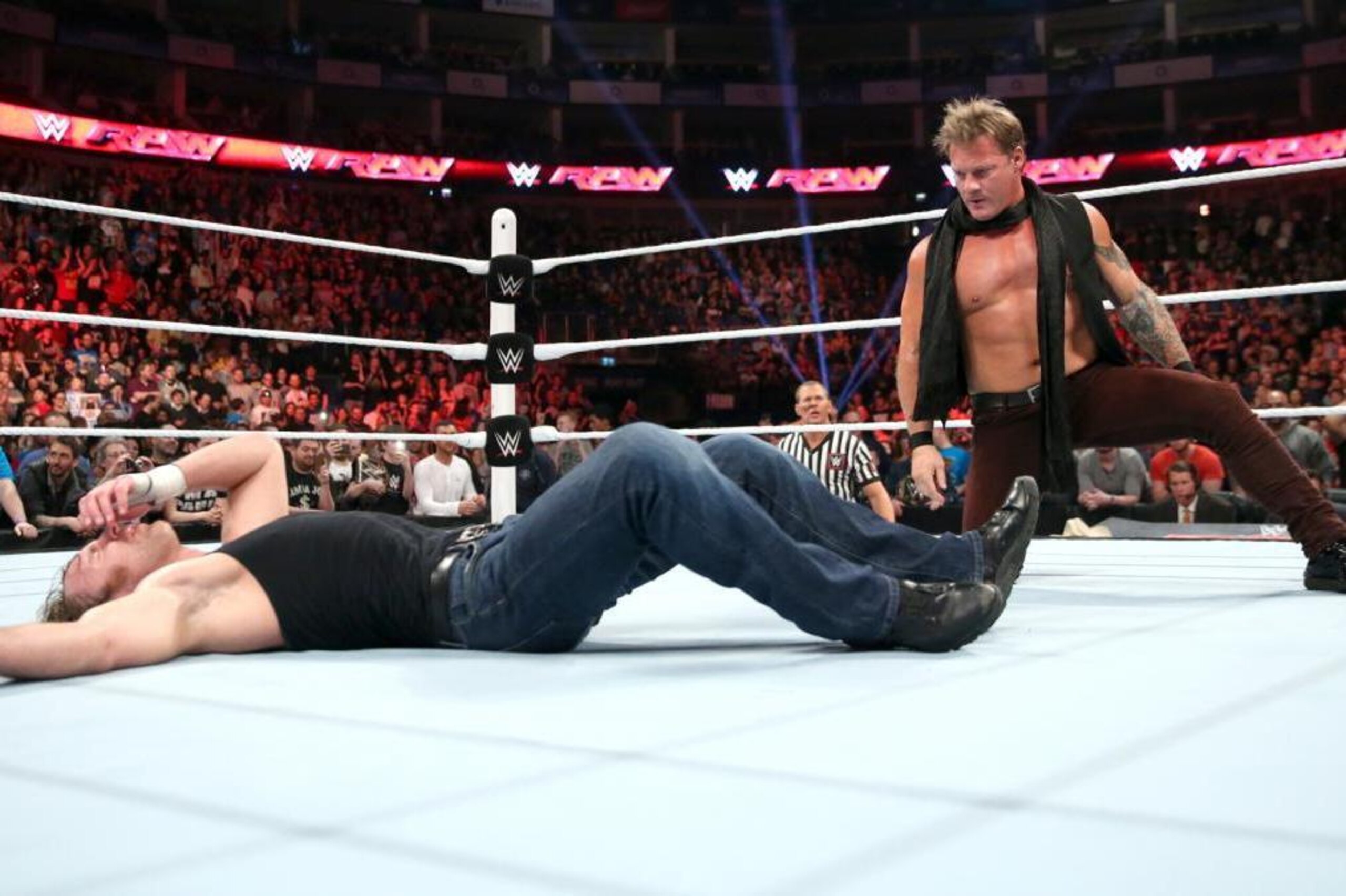 Chris Jericho admires his work after ambushing Dean Ambrose.