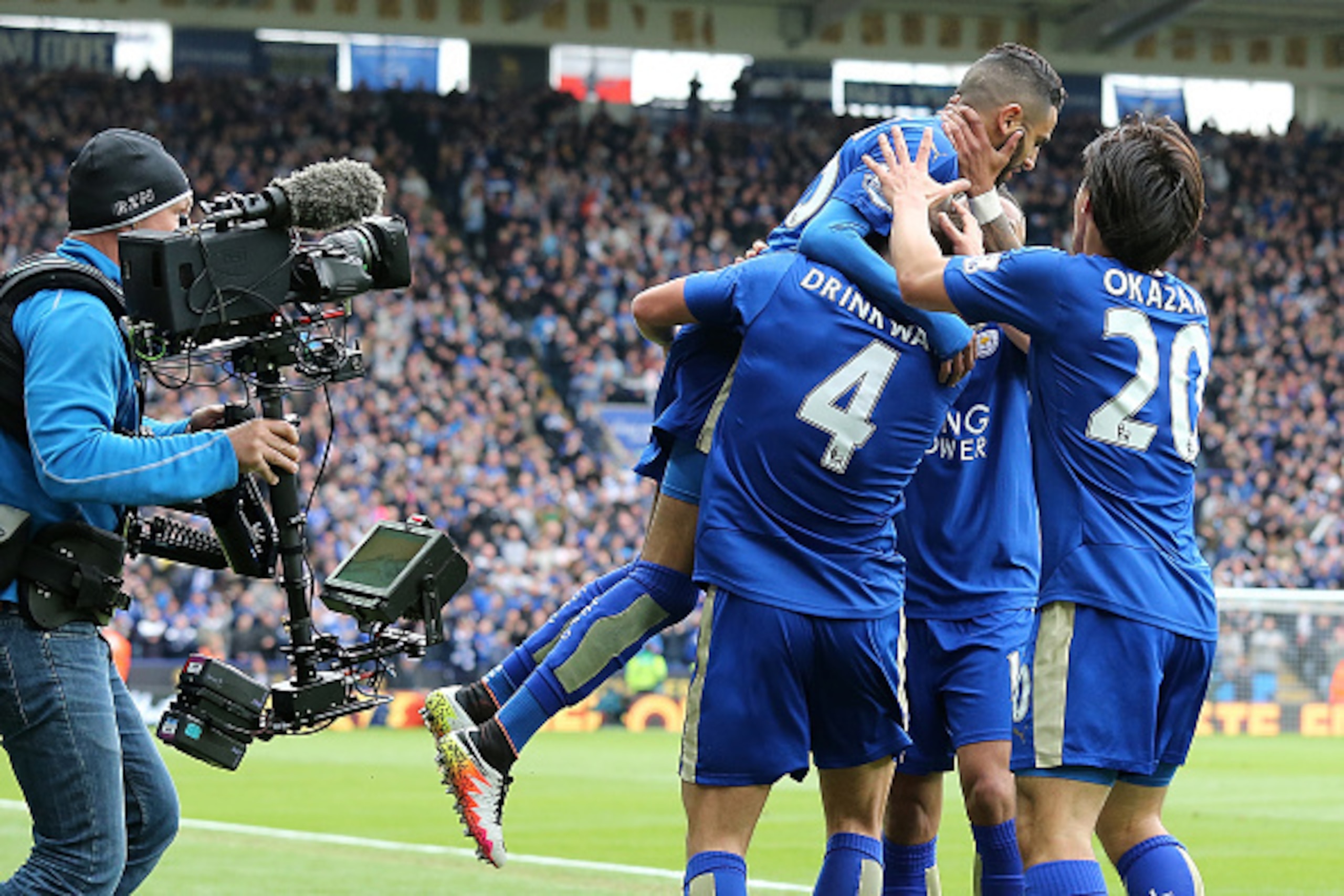 LEICESTER, ENGLAND - APRIL 24:  Riyad Mahrez of Leicester City celebrates with his team-mates after scoring a goal to make the score 1-0 during the Barclays Premier League match between Leicester City and Swansea City at The King Power Stadium on April 24