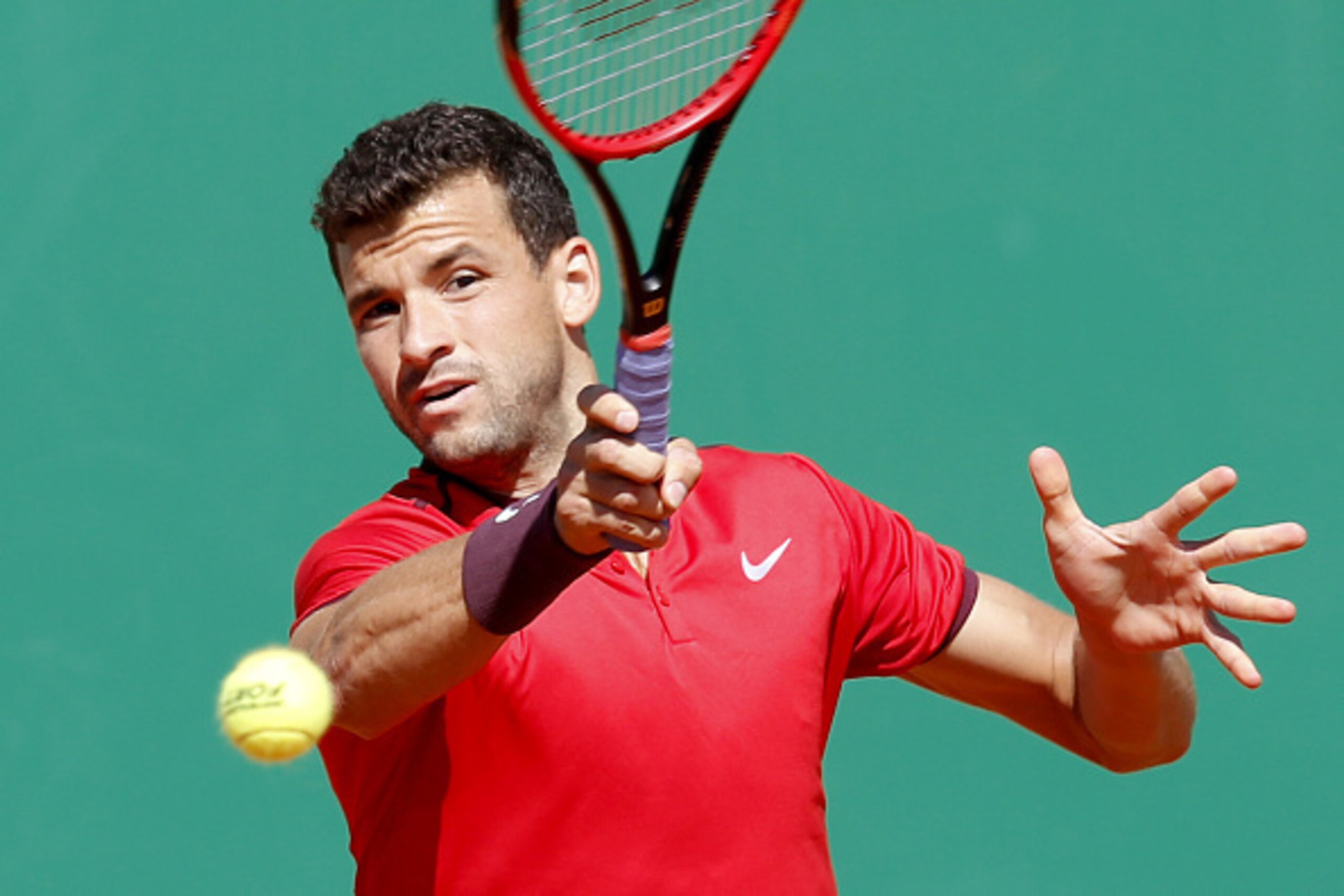 Bulgaria's Grigor Dimitrov returns the ball to France's Gilles Simon during the Monte-Carlo ATP Masters Series Tournament, on April 12, 2016 in Monaco.   AFP PHOTO / VALERY HACHE / AFP / VALERY HACHE        (Photo credit should read VALERY HACHE/AFP/Getty