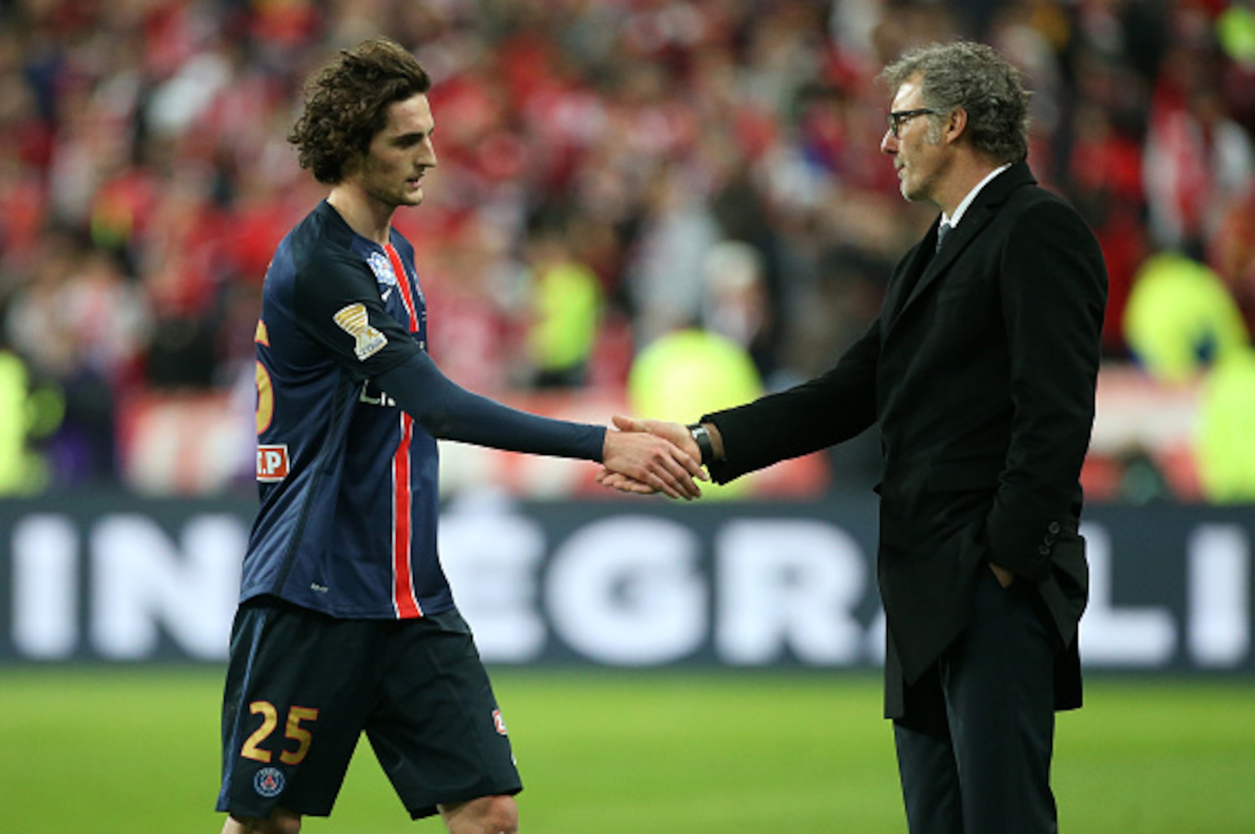 PARIS, FRANCE - APRIL 23: Adrien Rabiot of PSG shakes hands with coach of PSG Laurent Blanc when he leaves the field after receiving a red card during the French League Cup final (finale de la Coupe de la Ligue) between Paris Saint-Germain (PSG) and Lille