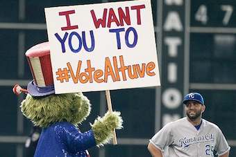 HOUSTON, TX - JUNE 29:  Kendrys Morales #25 of the Kansas City Royals looks at Houston Astros mascot Orbit as he campaigns for All-Star votes for Jose Altuve at Minute Maid Park on June 29, 2015 in Houston, Texas.  (Photo by Bob Levey/Getty Images)