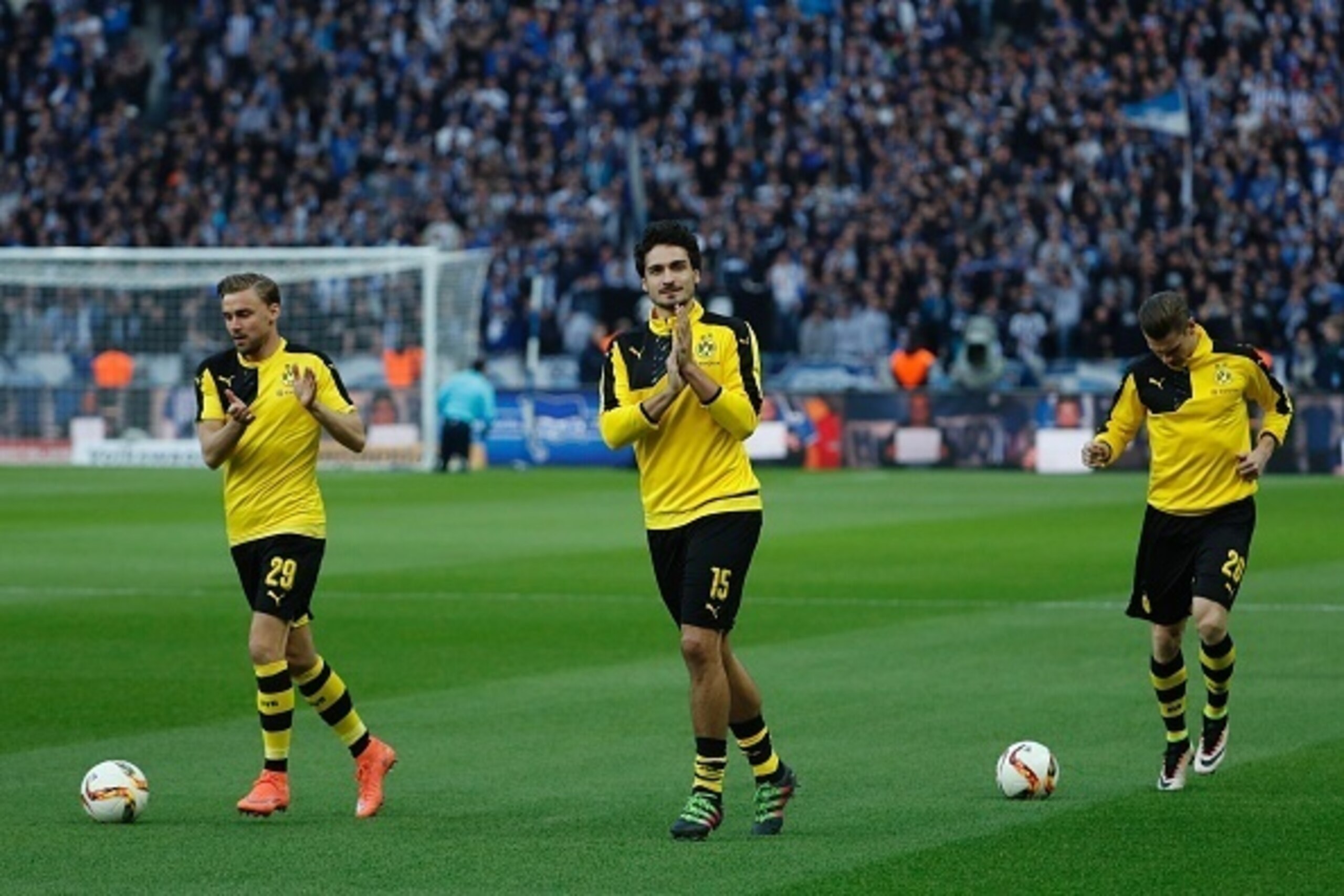Dortmund's defender Marcel Schmelzer, Dortmund's defender Mats Hummels and Dortmund's Polish defender Lukasz Piszczek warm up prior to the German Cup (DFB Pokal) semi-final football match Hertha Berlin v Borussia Dortmund at the Olympic stadium in Berlin 