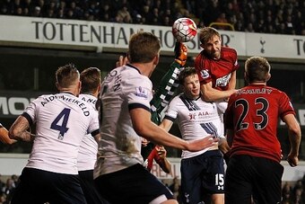 West Bromwich Albion's English defender Craig Dawson (Top) scores his team's first goal during the English Premier League football match between Tottenham Hotspur and West Bromwich Albion at White Hart Lane in London, on April 25, 2016. / AFP / IKimages /