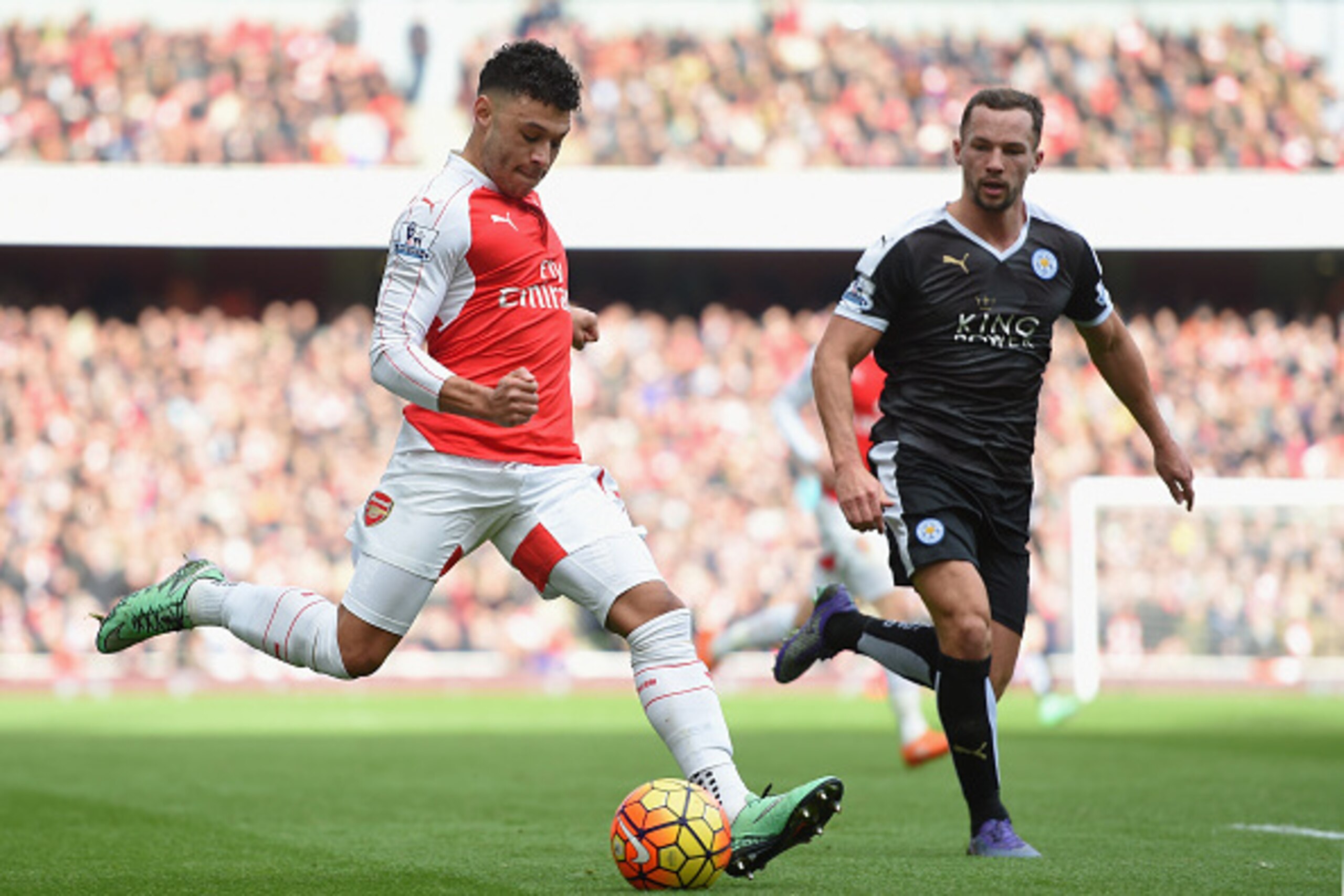 LONDON, ENGLAND - FEBRUARY 14:  Alex Oxlade-Chamberlain of Arsenal takes on Danny Drinkwater of Leicester City during the Barclays Premier League match between Arsenal and Leicester City at the Emirates Stadium.  (Photo by Michael Regan/Getty Images)