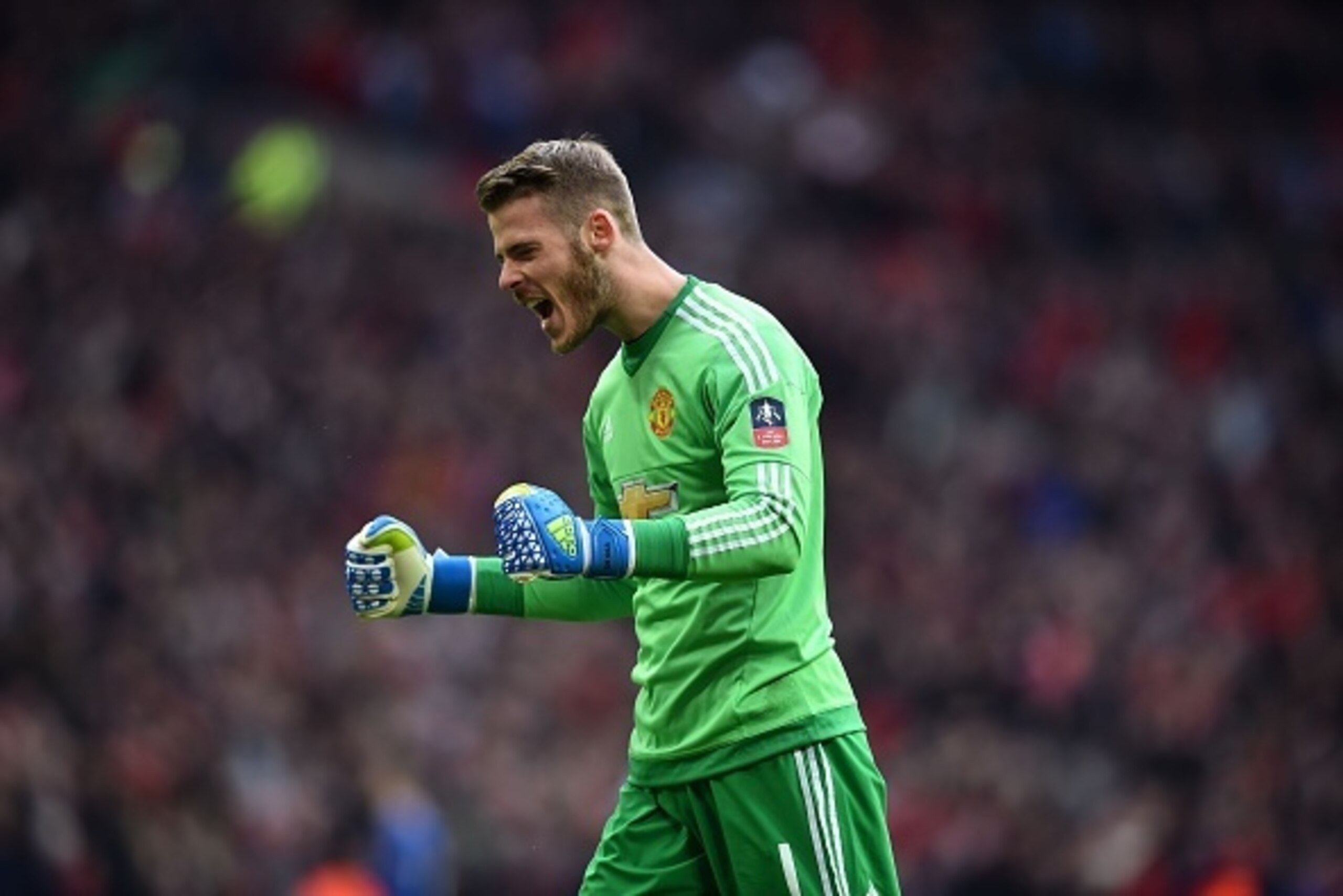 Manchester United's Spanish goalkeeper David de Gea celebrates after Manchester United's French striker Anthony Martial scored their second goal during the English FA Cup semi-final football match between Everton and Manchester United at Wembley Stadium i