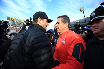 ANN ARBOR, MI - NOVEMBER 28: Head coach Urban Meyer of the Ohio State Buckeyes and head coach Jim Harbaugh of the Michigan Wolverines after the game against the Michigan Wolverines at Michigan Stadium on November 28, 2015 in Ann Arbor, Michigan. Ohio Stat