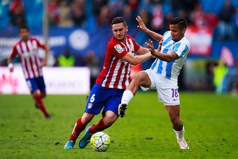 MADRID, SPAIN - APRIL 23: Koke (L) of Atletico de Madrid competes for the ball with Roberto Rosales (R) of Malaga CF during the La Liga match between Club Atletico de Madrid and Malaga CF at Vicente Calderon Stadium on April 23, 2016 in Madrid, Spain.  (P
