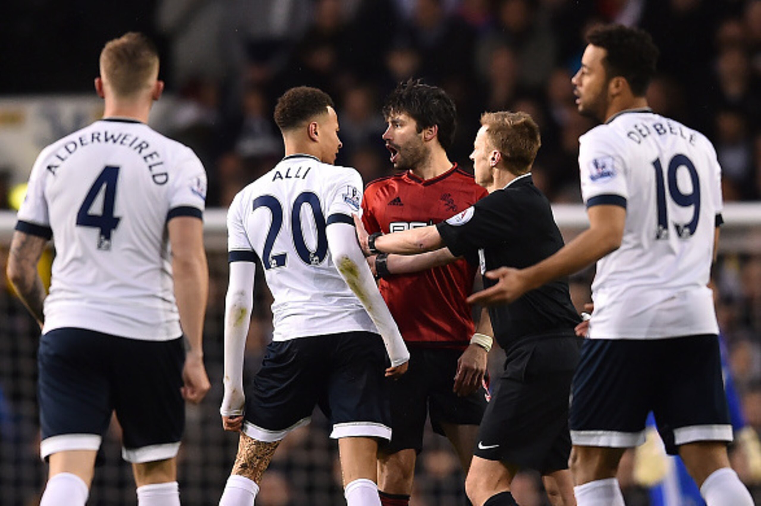 Tottenham Hotspur's English midfielder Dele Alli (2nd L) speaks with West Bromwich Albion's Argentinian midfielder Claudio Yacob (3rd R) following a challenge during the English Premier League football match between Tottenham Hotspur and West Bromwich Alb