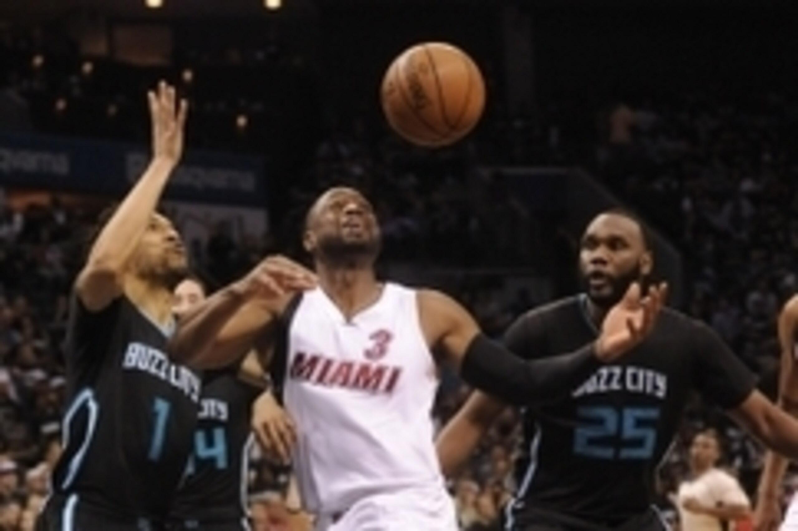 Apr 23, 2016; Charlotte, NC, USA; Miami Heat guard Dwyane Wade (3) catches a pass as he is defended by Charlotte Hornets forward Courtney Lee (1) and forward center Al Jefferson (25) during the second half in game three of the first round of the NBA Playo