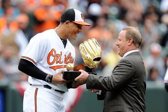 BALTIMORE, MARYLAND - APRIL 04:  Manny Machado #13 of the Baltimore Orioles receives his Gold Glove award before the game against the Minnesota Twins at Oriole Park at Camden Yards on April 4, 2016 in Baltimore, Maryland.  (Photo by G Fiume/Getty Images)