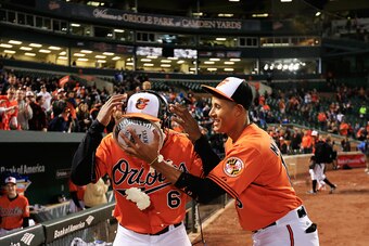 BALTIMORE, MD - APRIL 11: Manny Machado #13 of the Baltimore Orioles hits teammate Jonathan Schoop #6 in the face with a pie after the Orioles defeated the Toronto Blue Jays 7-1 at Oriole Park at Camden Yards on April 11, 2015 in Baltimore, Maryland.  (Ph