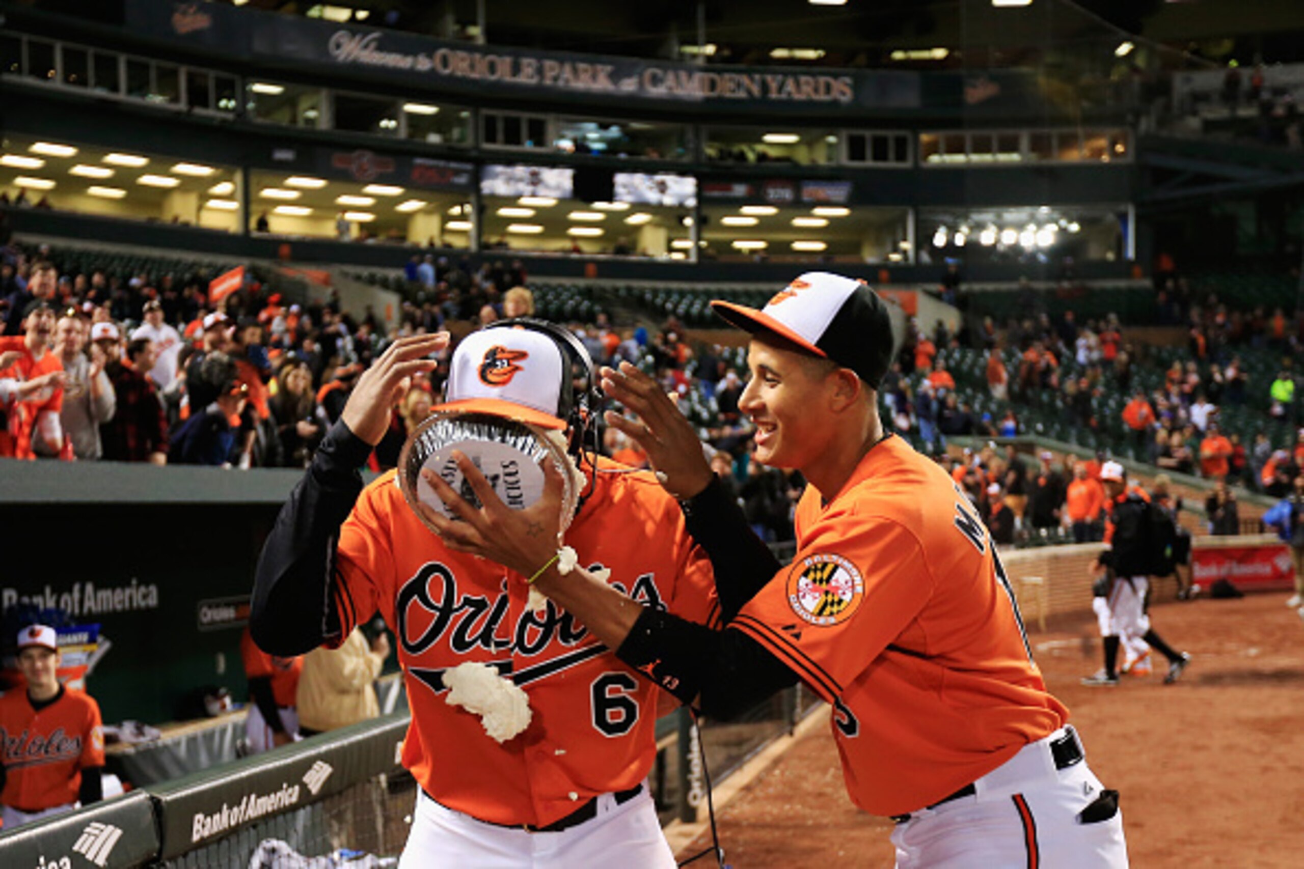 BALTIMORE, MD - APRIL 11: Manny Machado #13 of the Baltimore Orioles hits teammate Jonathan Schoop #6 in the face with a pie after the Orioles defeated the Toronto Blue Jays 7-1 at Oriole Park at Camden Yards on April 11, 2015 in Baltimore, Maryland. (Ph BALTIMORE, MD - APRIL 11: Manny Machado #13 of the Baltimore Orioles hits teammate Jonathan Schoop #6 in the face with a pie after the Orioles defeated the Toronto Blue Jays 7-1 at Oriole Park at Camden Yards on April 11, 2015 in Baltimore, Maryland. (Ph