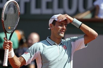 Serbia's Novak Djokovic reacts after a point against Spain's Rafael Nadal during their French tennis Open semi final match at the Roland Garros stadium in Paris on June 7, 2013. AFP PHOTO / THOMAS COEX        (Photo credit should read THOMAS COEX/AFP/Gett