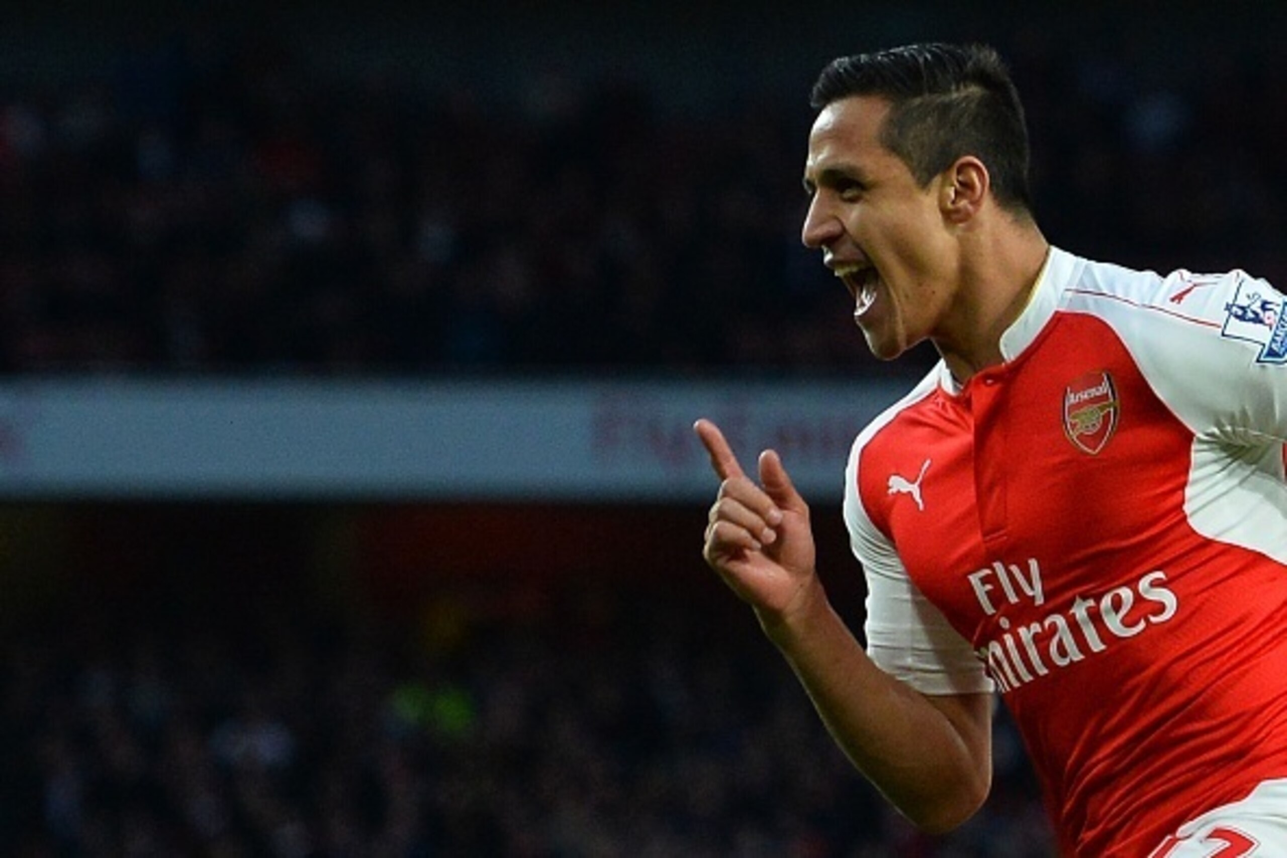 Arsenal's Chilean striker Alexis Sanchez celebrates scoring the opening goal during the English Premier League football match between Arsenal and West Bromwich Albion at the Emirates Stadium in London on April 21, 2016.  / AFP / GLYN KIRK / RESTRICTED TO 