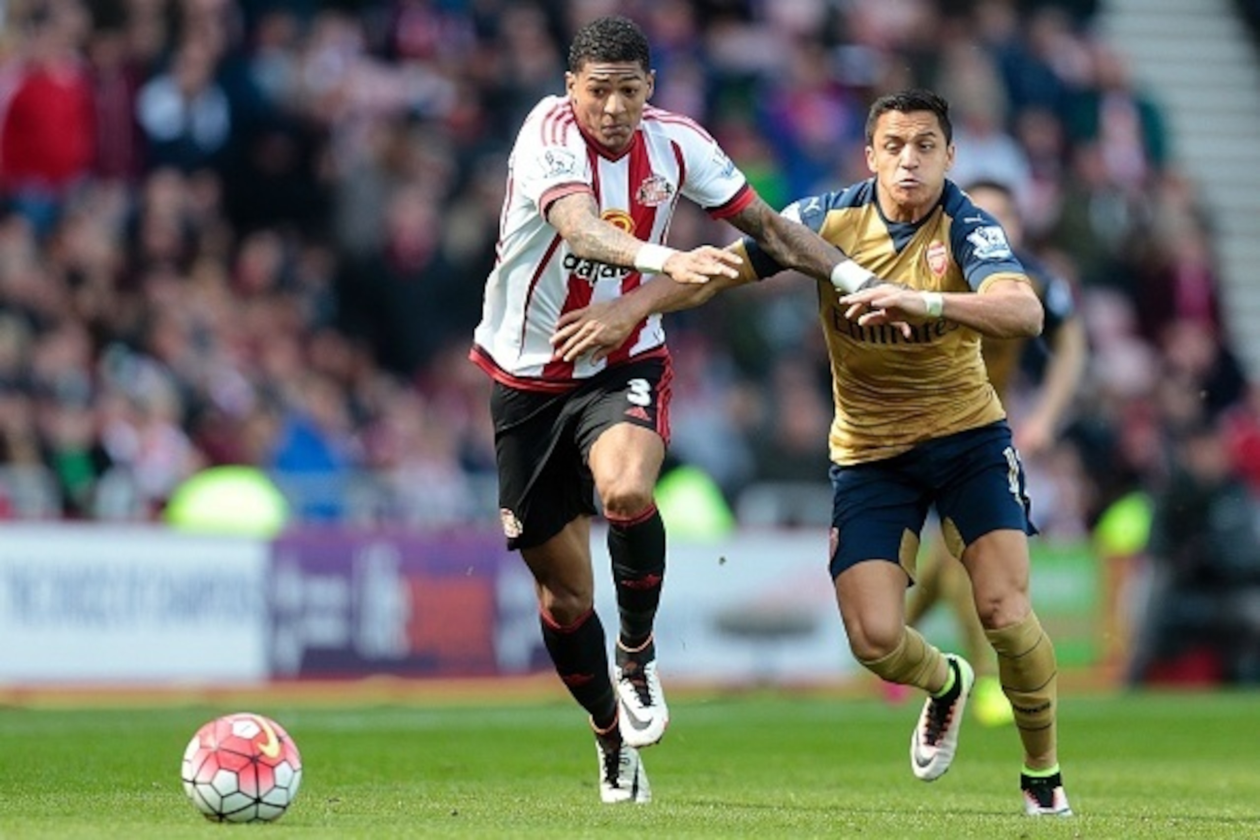 Arsenal's Chilean striker Alexis Sanchez (R) challenges Sunderland's Dutch defender Patrick van Aanholt during the English Premier League football match between Sunderland and Arsenal at the Stadium of Light in Sunderland, northeast England on April 24, 2