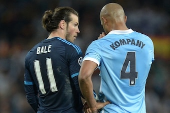 Manchester City's Belgian defender Vincent Kompany (R) talks with Real Madrid's Welsh forward Gareth Bale (L) after the final whistle during the UEFA Champions League semi-final first leg football match between Manchester City and Real Madrid at the Etiha