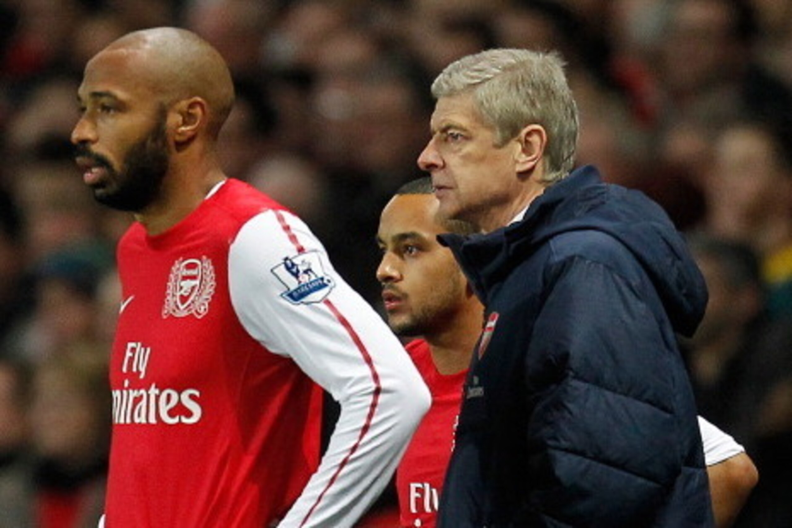 (FILES) In this file picture taken on January 9, 2012 Arsenal's French player Thierry Henry (L) stands next to team-mate Theo walcott (C) and manager Arsene Wenger (R) as he prepares to substitute for a team-mate during the third round FA Cup football mat